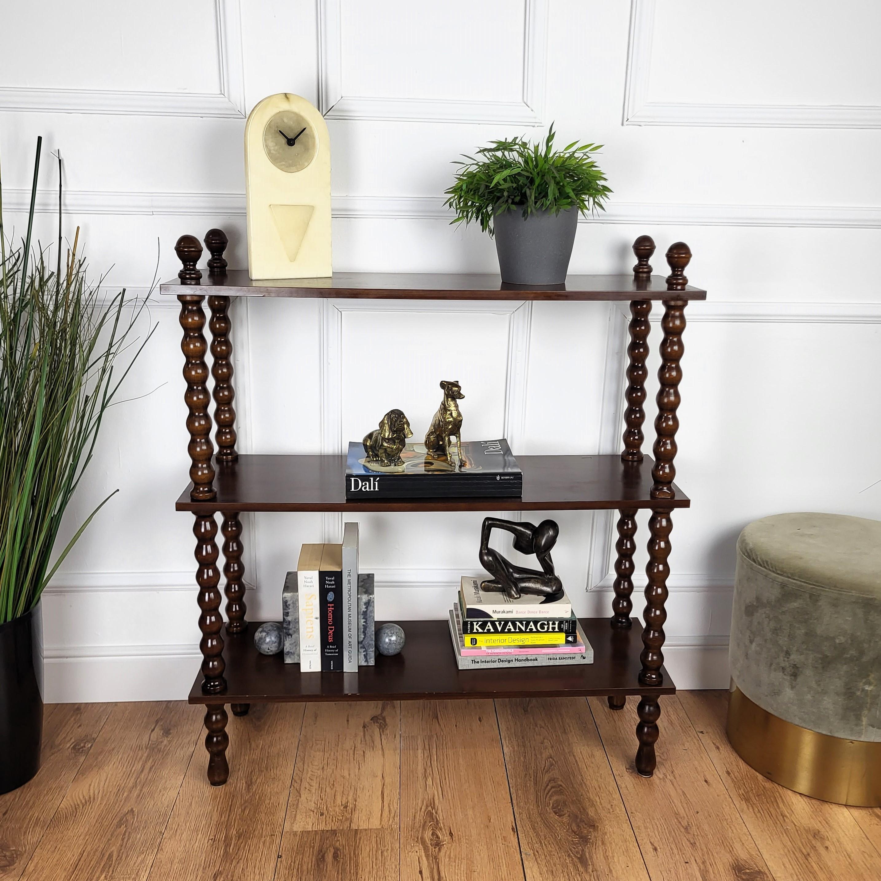 A beautiful Italian antique walnut three shelves, open bookcase or etagere standing on four great shaped carved turned wooden legs with top finials. 