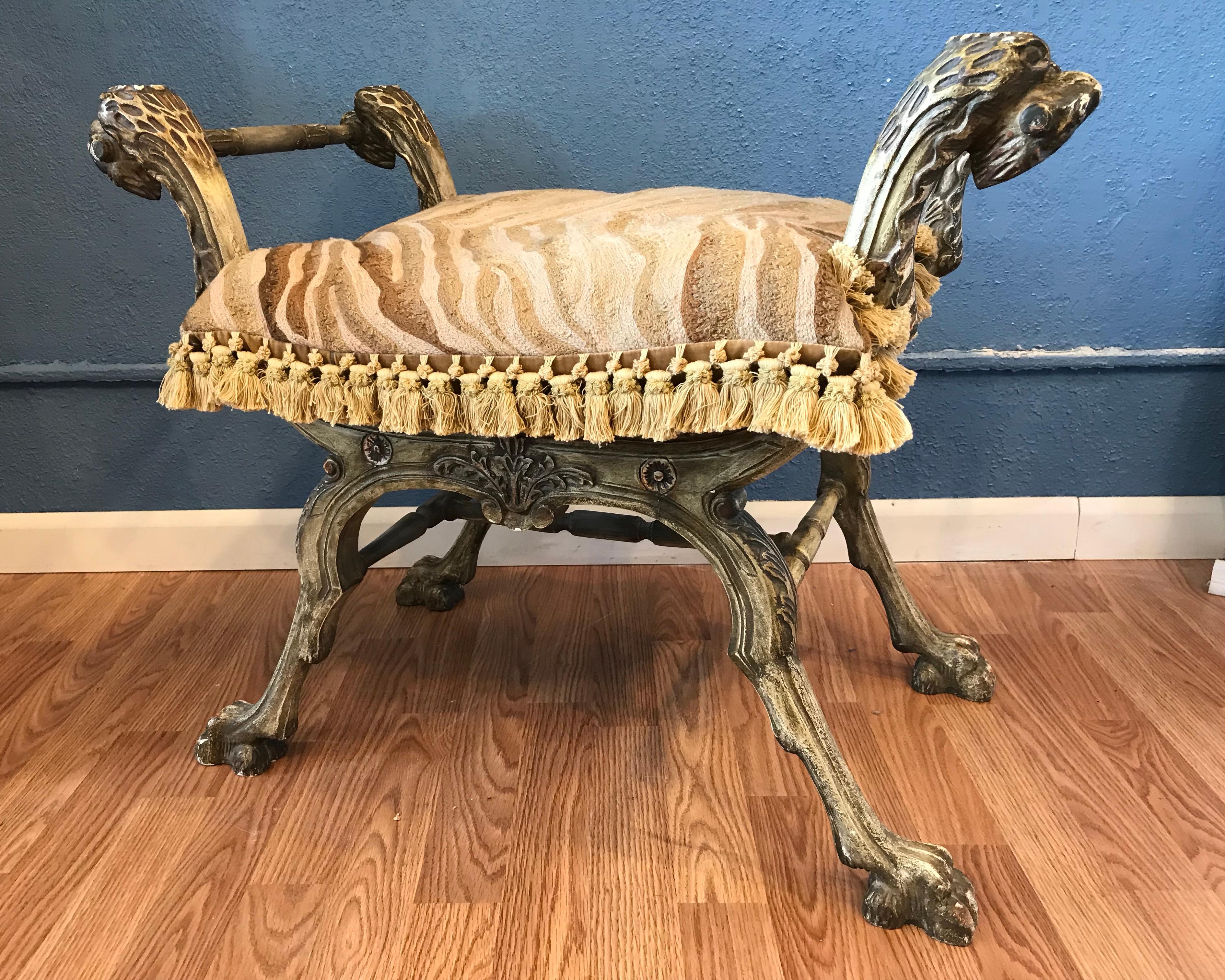 A fanciful vintage bench. It is fashioned with griffin - like heads at each corner.
The sharply carved bench terminates with 