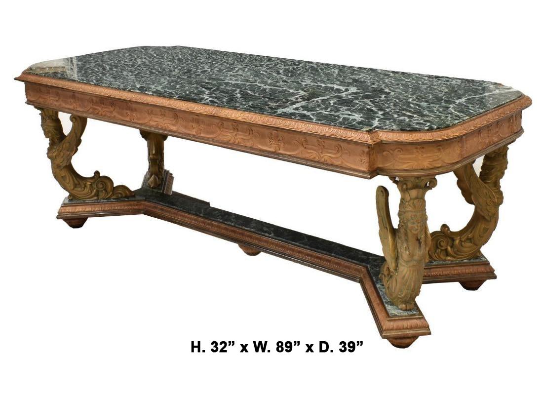 Impressive Italian finely carved fruitwood dining table with Verde antico green marble top,
first half of the 20th century. 

The shaped Verde antico green marble top is inset into a conforming frieze intricately carved in a Fleur-de-lis and