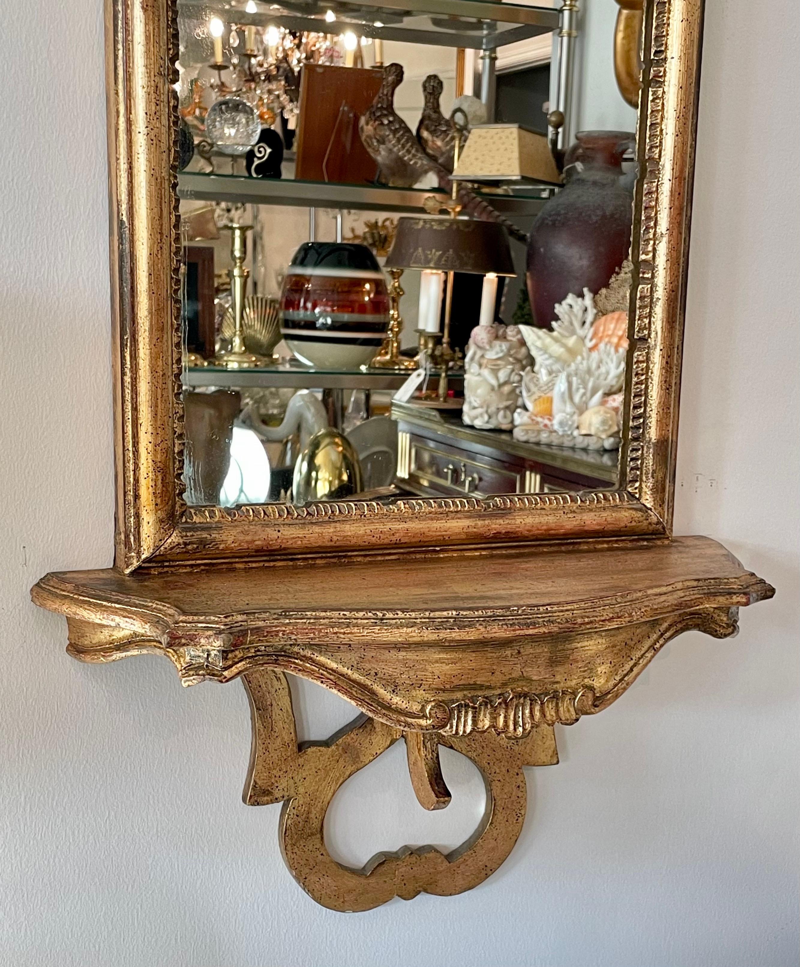 Hand carved & gilded Italian mirror with shelf for display. Very nice carved details.
Simple, yet very elegant.