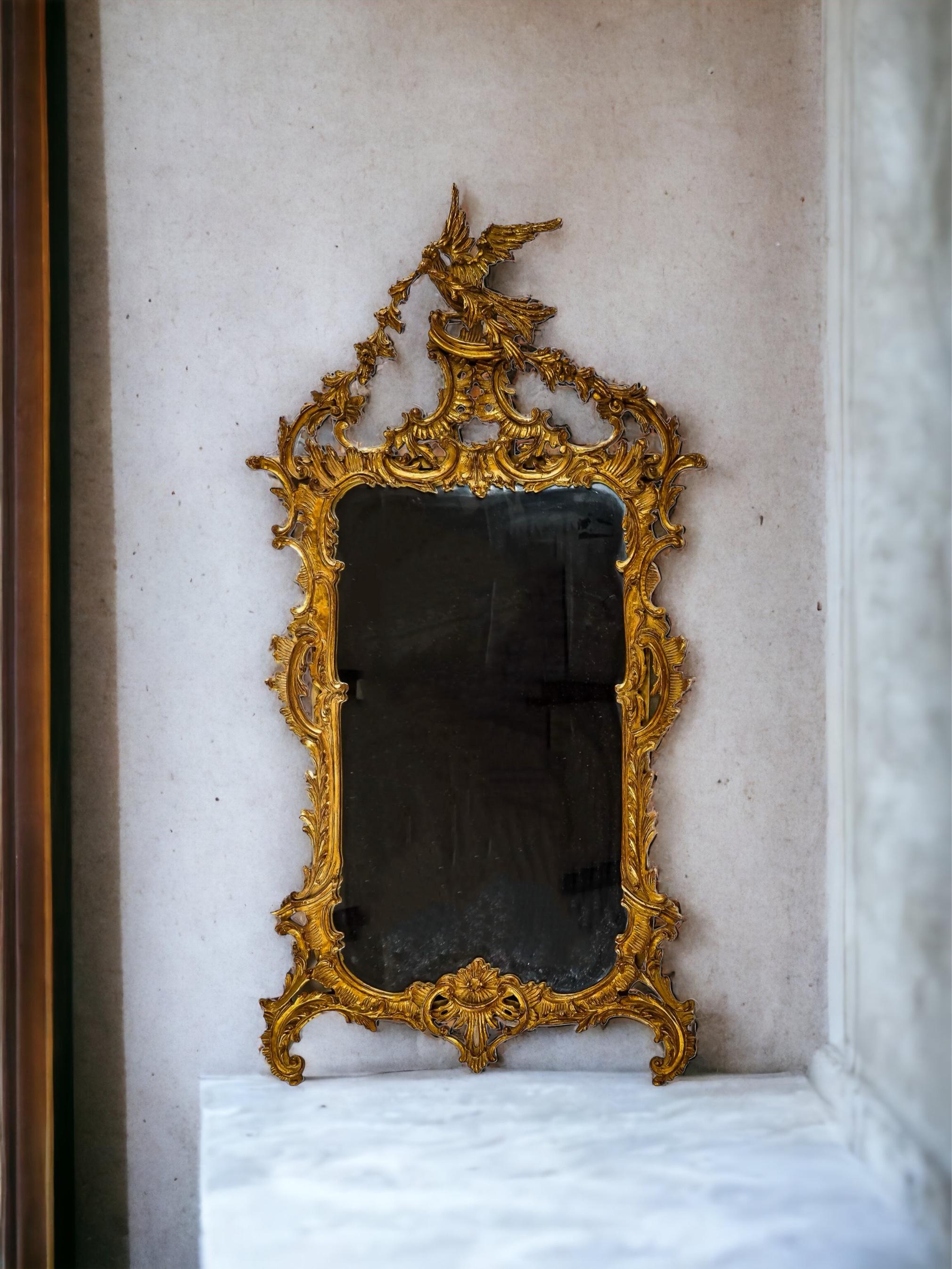 This is an Italian Chinese chippendale style carved giltwood mirror by Carver’s Gild. It is a really nice scale, and note the Ho Ho bird with the draping garland. It is marked and in very good condition.