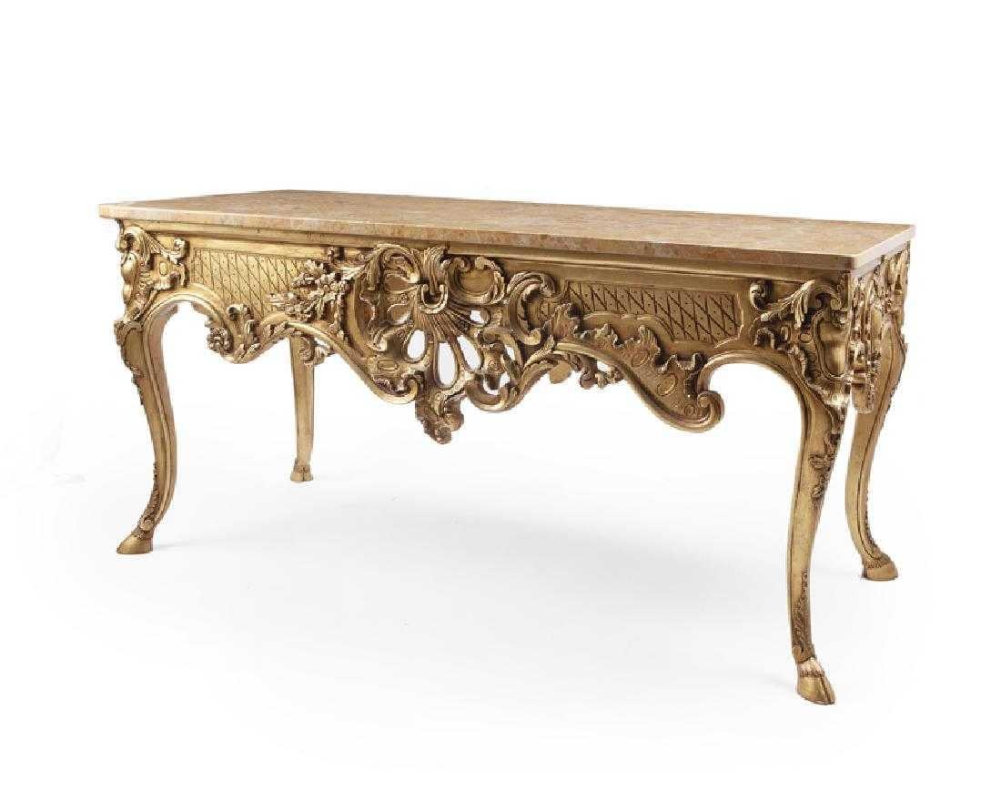 Impressive Italian carved giltwood console with marble top. Second half of the 20th Century.
The beautiful rectangular red and yellow marble top over an intricately carved giltwood frieze centered by pierced rocaille ornamentation with scrolling