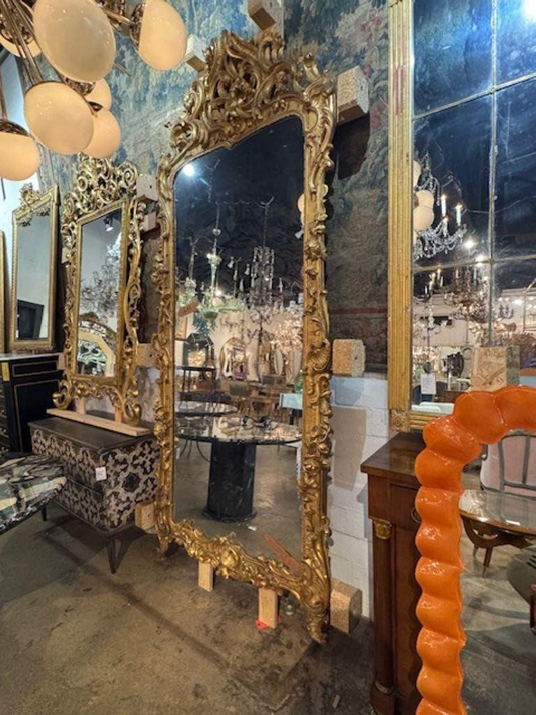 Magnifique miroir italien du 19e siècle en bois sculpté et dor�é. Un miroir italien en bois doré sculpté est une pièce antique luxueuse, souvent dotée d'un cadre ornemental sculpté à la main et fini à la feuille d'or, dont les styles vont du baroque