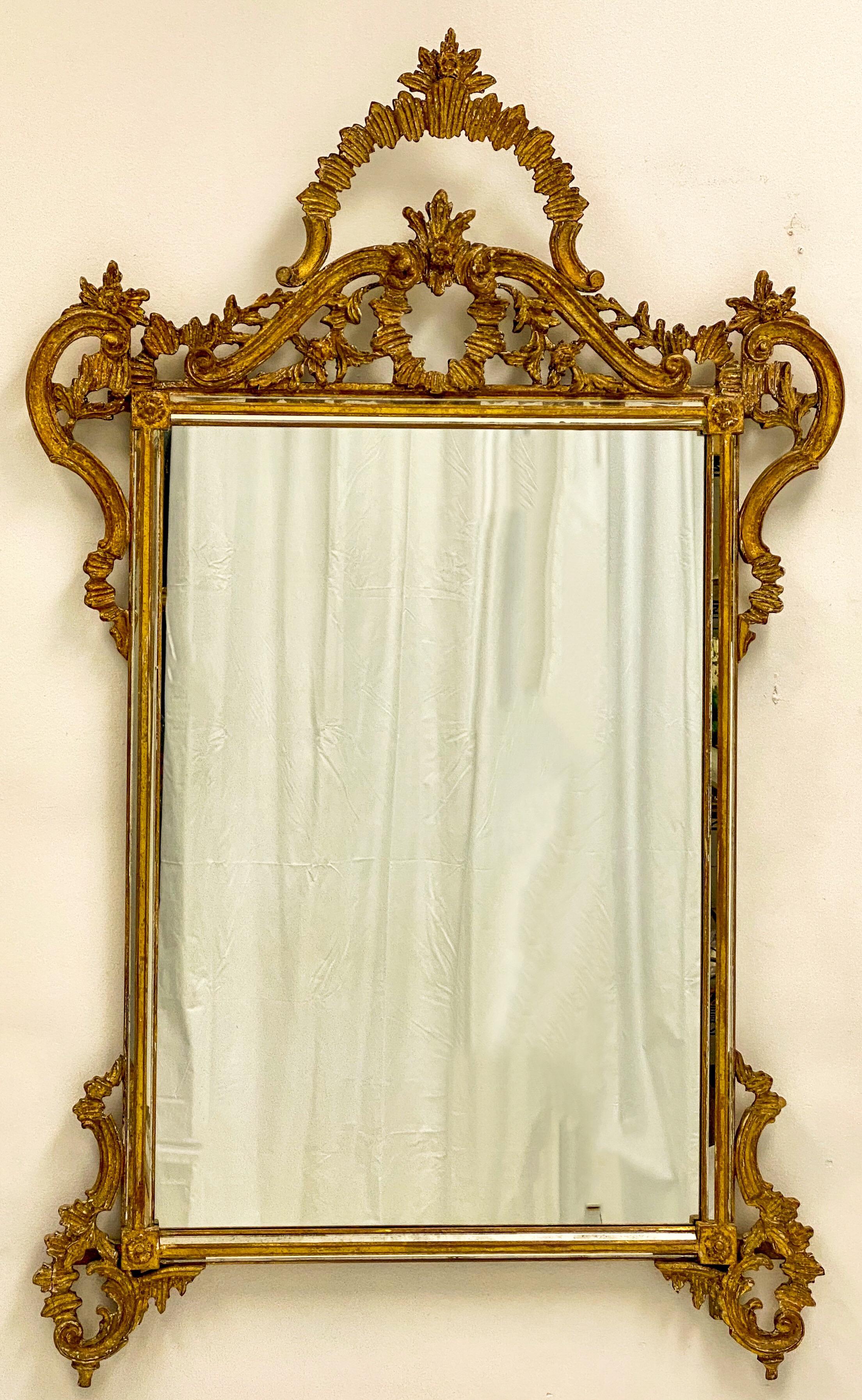 This is an Italian carved giltwood Rococo style mirror by Labarge. It is marked and shows some lite age wear to the ornate frame.