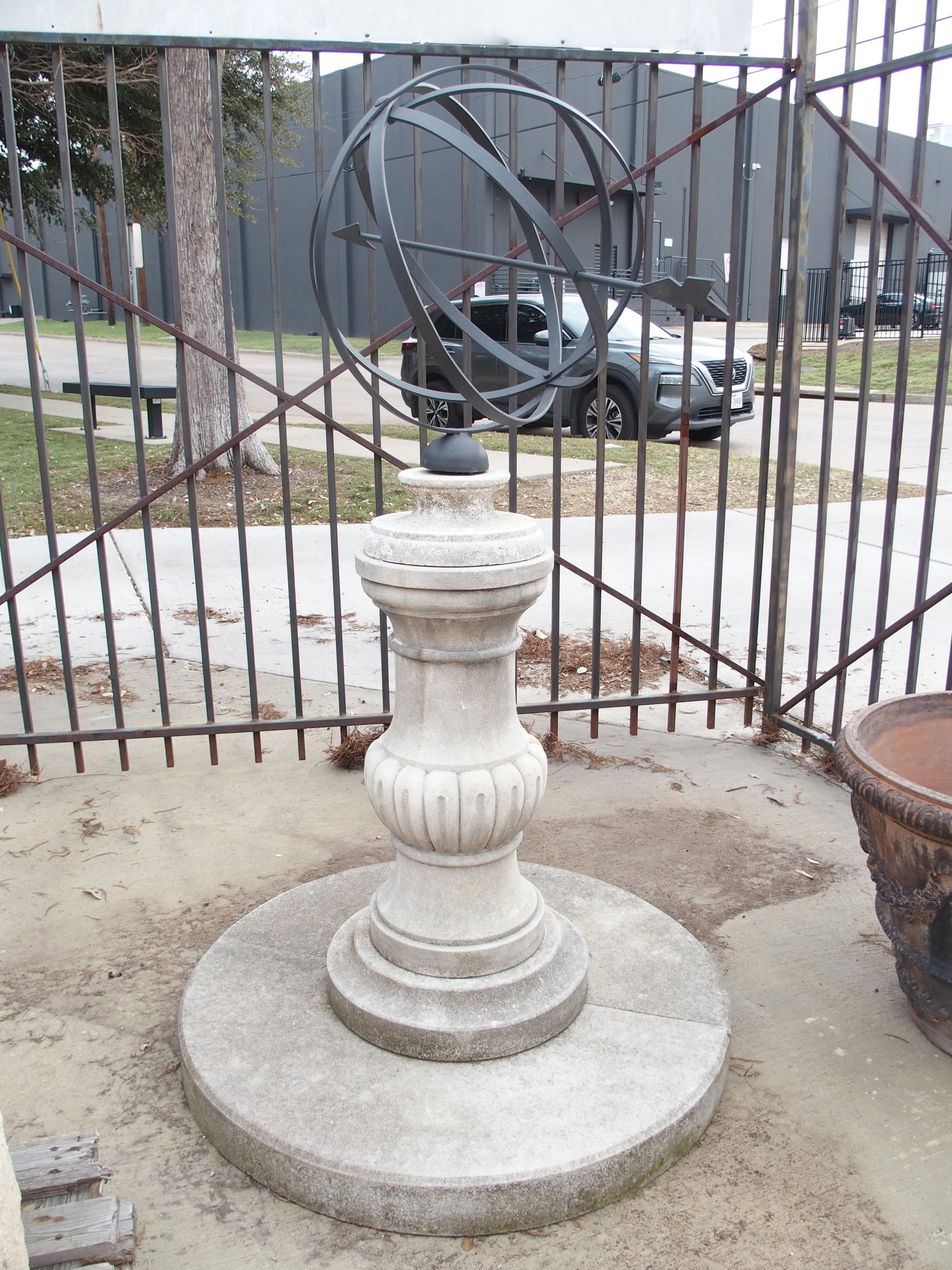 Topped by a four-ring iron armillary sphere with a lancing arrow gnomon, this sundial is supported by a baluster form column. Hand-carved from Italian limestone, the light gray stone has developed a striking patina of green, dark gray, and brown and