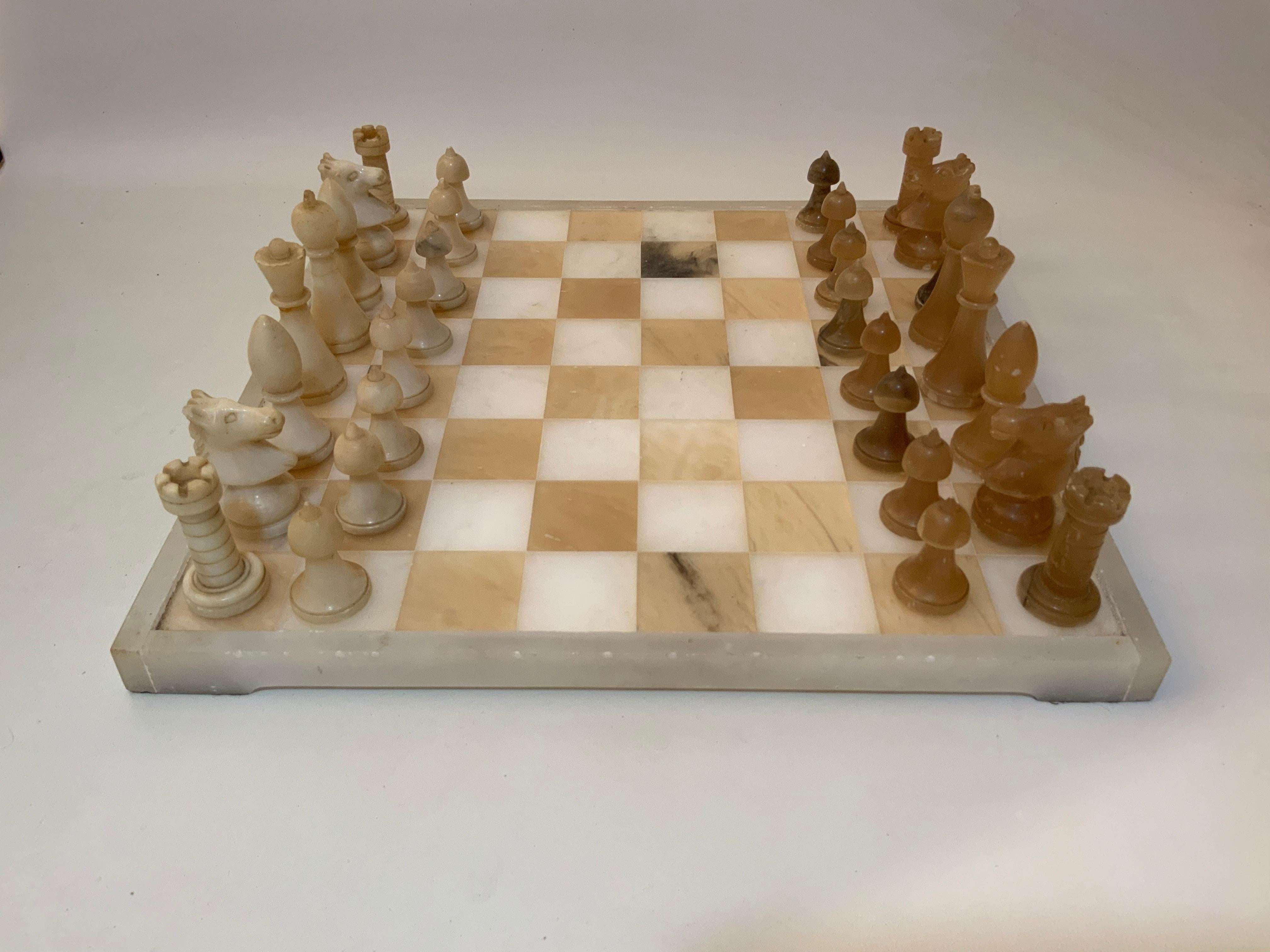 Complete circa 1930 carved marble chess set. Contains all its pieces that are beautifully carved and polished. Good condition with some minor bumps, dings, base chips and scratches. The white queen has an old glue repair to its crown and the white