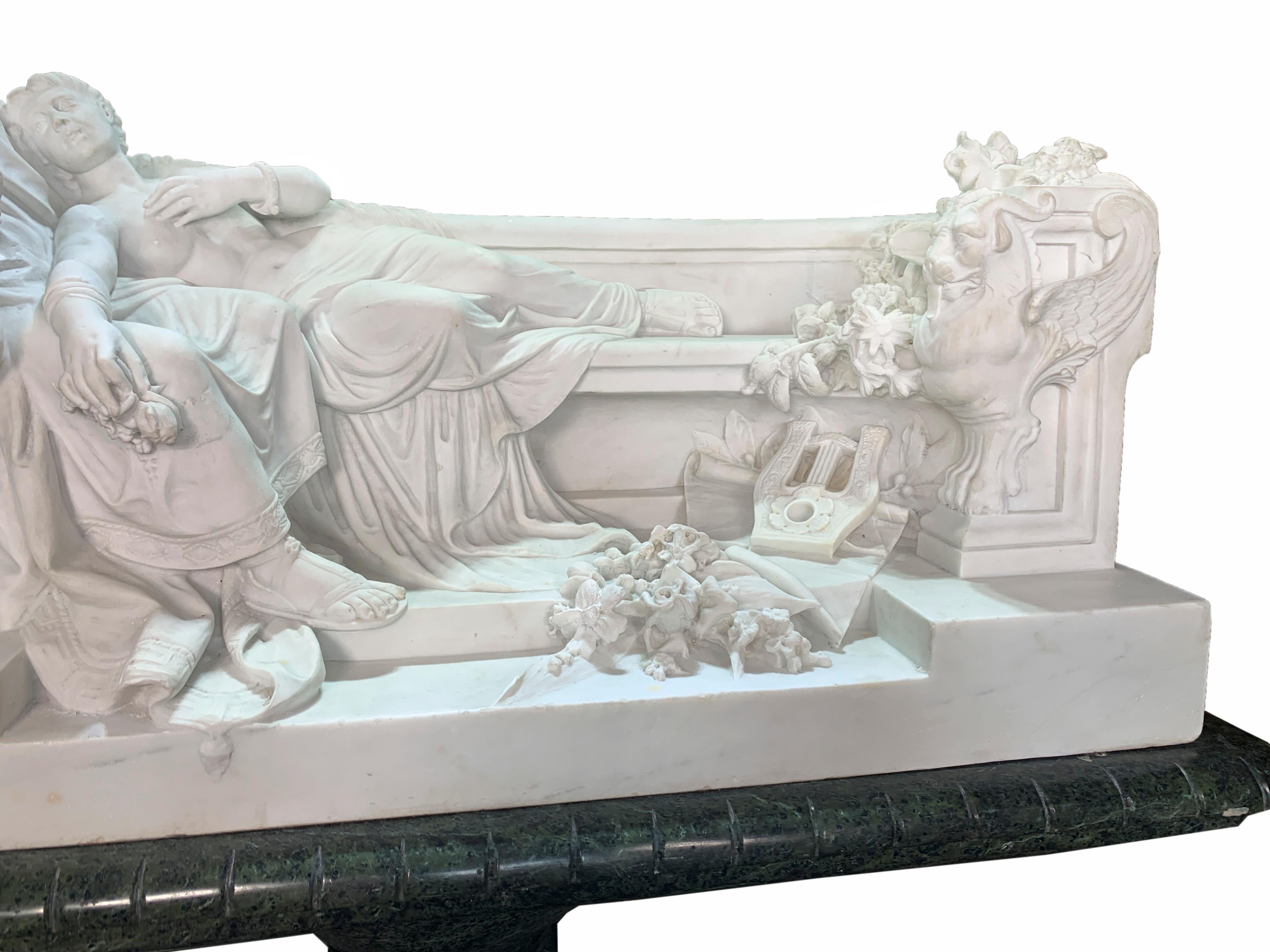 A stunning 19th century Neo-Classical style hand carved white Carrara marble figural group depicting a semi nude lady reclining by a Roman caesar seated on a D-shaped bench flanked by two carved griffins. This remarkable and detailed lovers marble