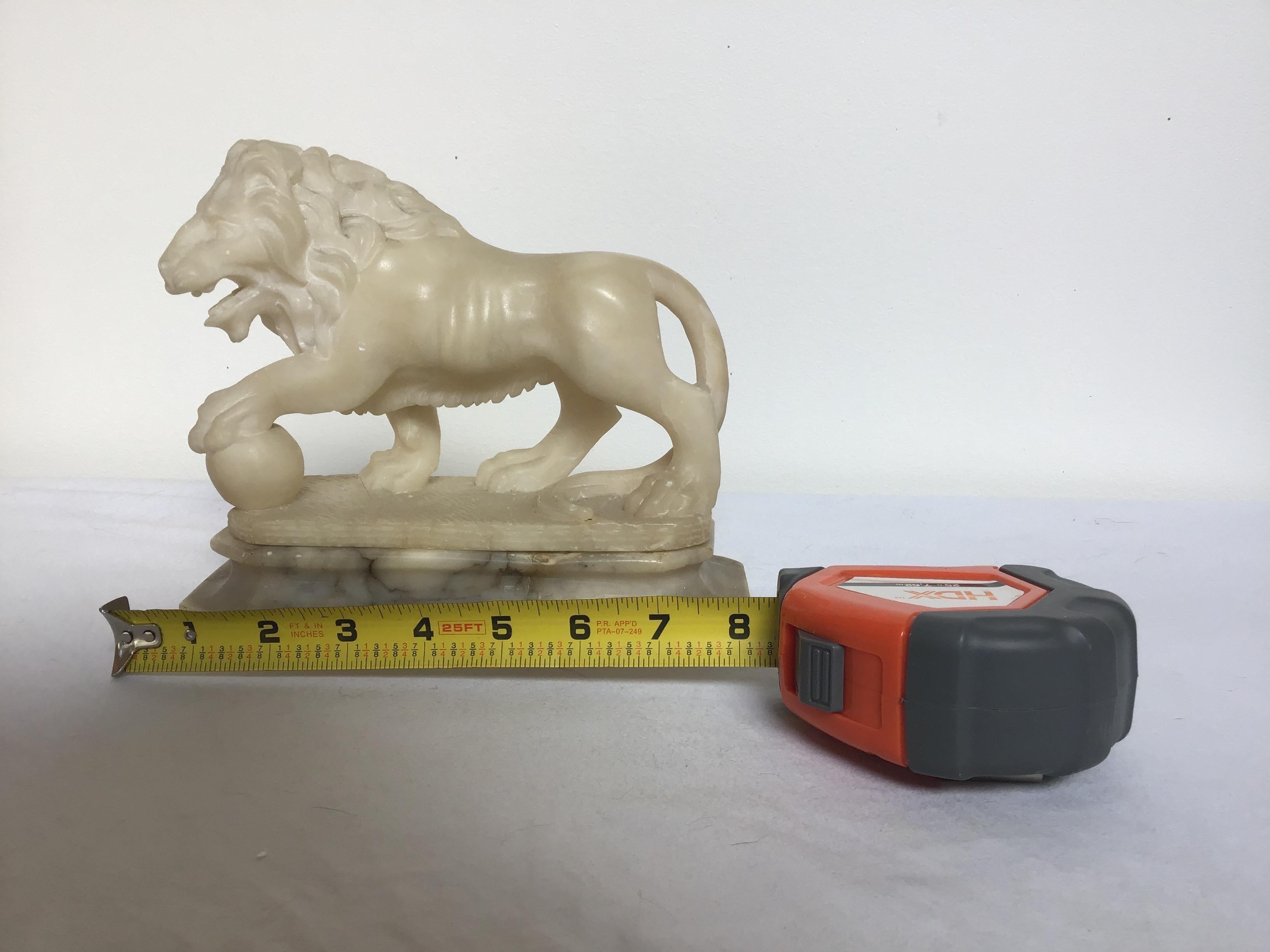 Carved marble lion on base. Base is separate.