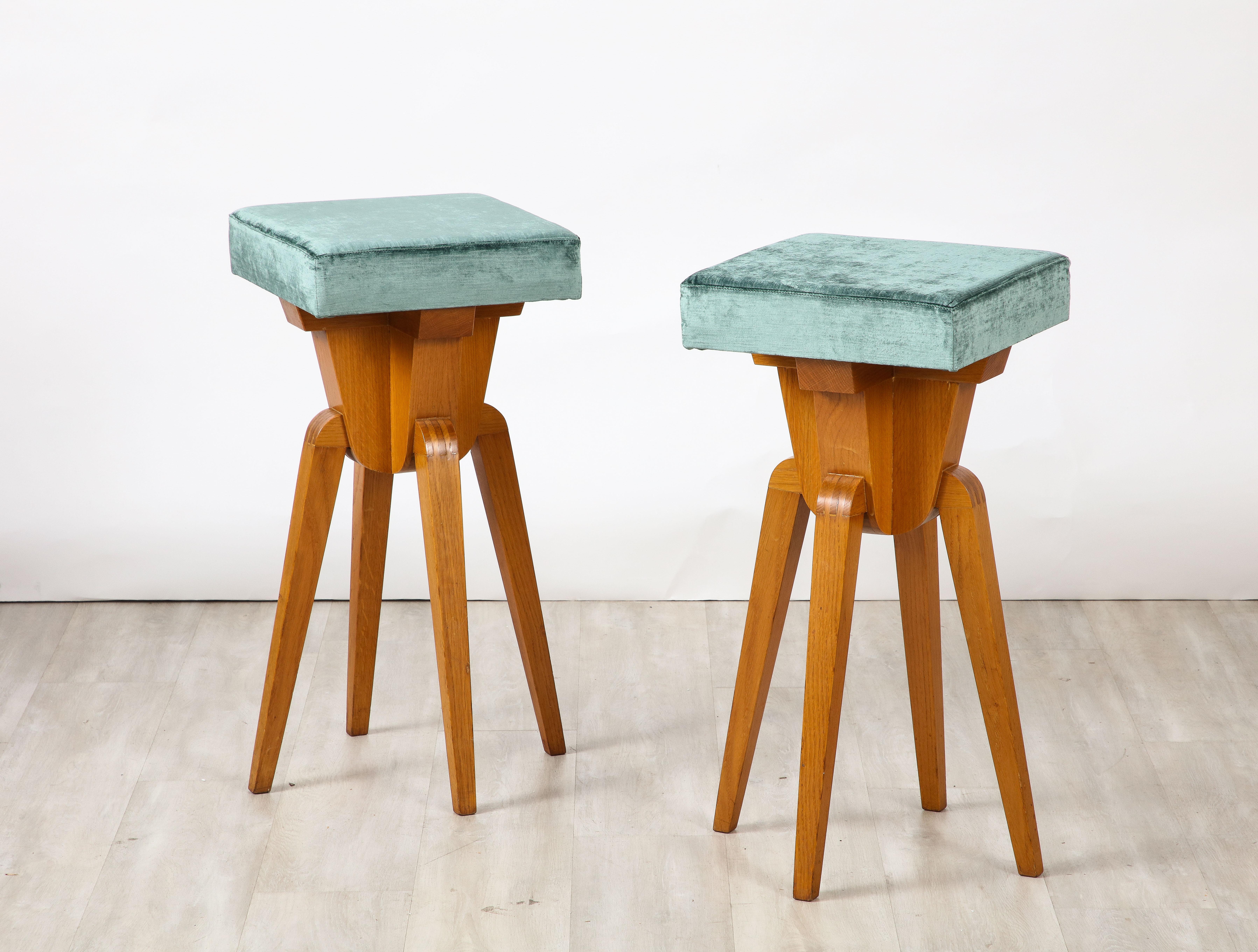 Italian modernist carved oak bar stools, highly sculptural with square seats.  Very unique, would add a special element to a kitchen or bar. Newly re-upholstered in an Italian velvet of turquoise/teal coloring. 
Northern Italy, circa 1950 
Size: 29