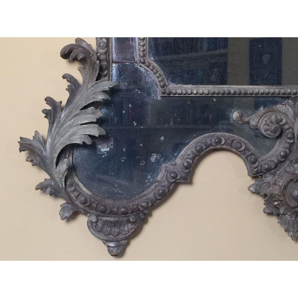 Antique Italian hand-carved Rococo mirror of impressive proportions, circa 1820.
Crisply and deeply carved overall with acanthus and with a bold scallop shell cresting.
The original divided plates enclosed by well carved foliate borders and