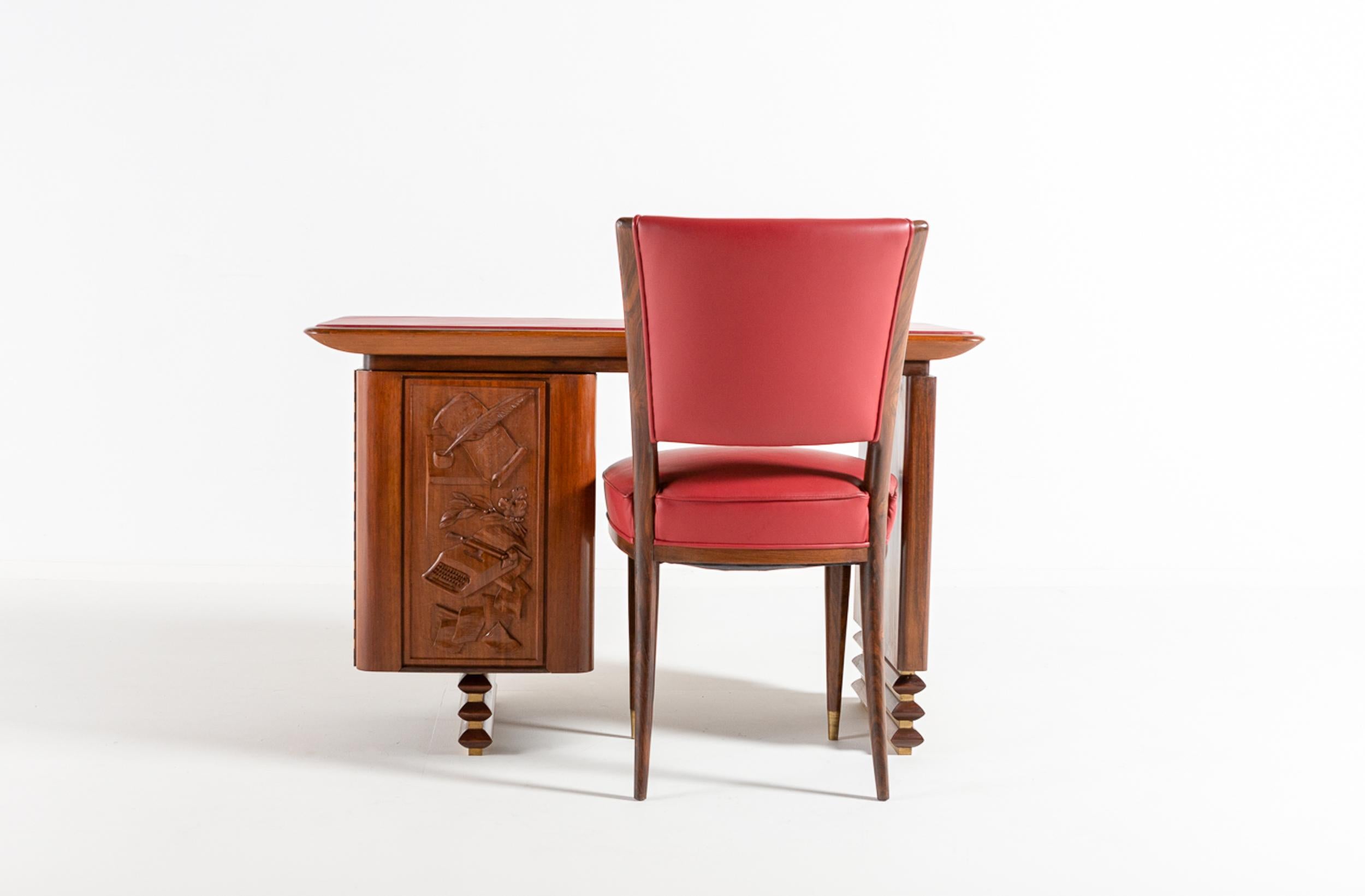 A superb Italian walnut and rosewood desk with matching rosewood and leather side chair, made to measure for the villa of an Italian executive in 1960. The rectangular top is covered with the original red leather. The front of the hidden drawer unit