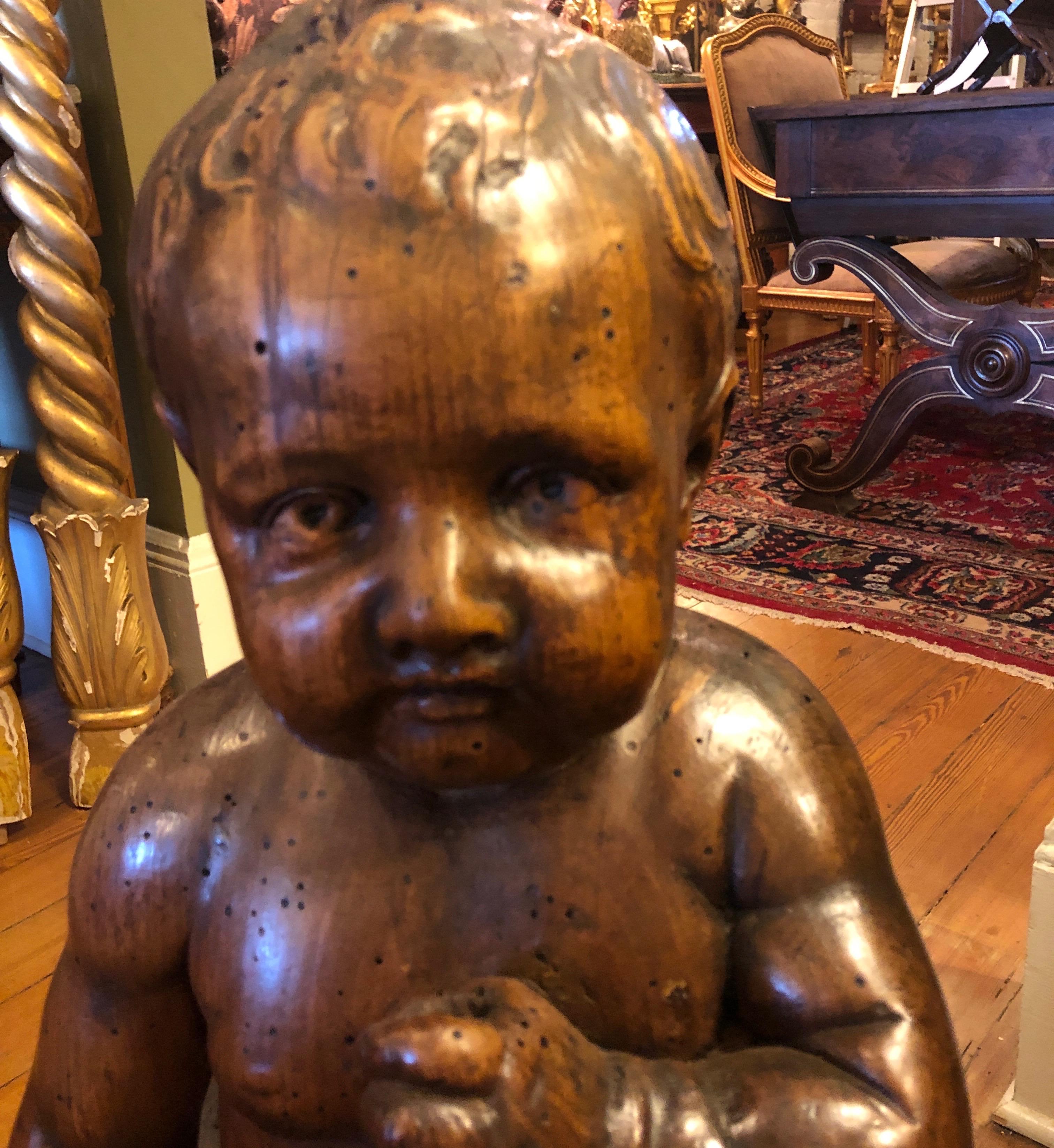 Italian Carved Walnut Baby on Cushion For Sale 1