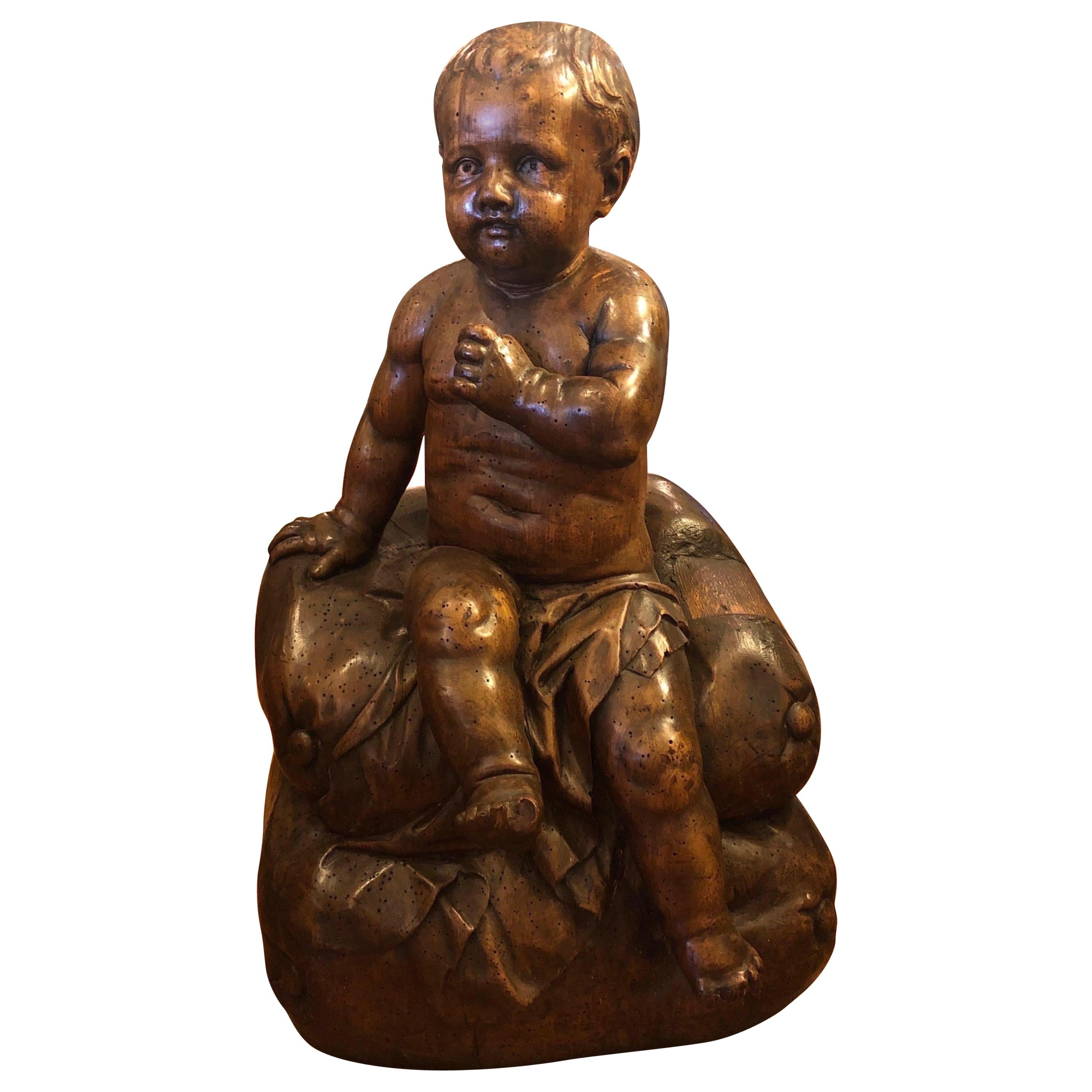 Italian Carved Walnut Baby on Cushion For Sale