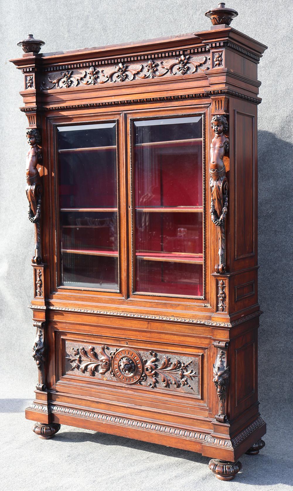 This is a wonderful carved walnut bookcase from Italy. Look at the incredible carving and quality of this bookcase. Notice the mythical creatures and cherubs and lions that adorn this spectacular bookcase! This is a 2-piece bookcase and is