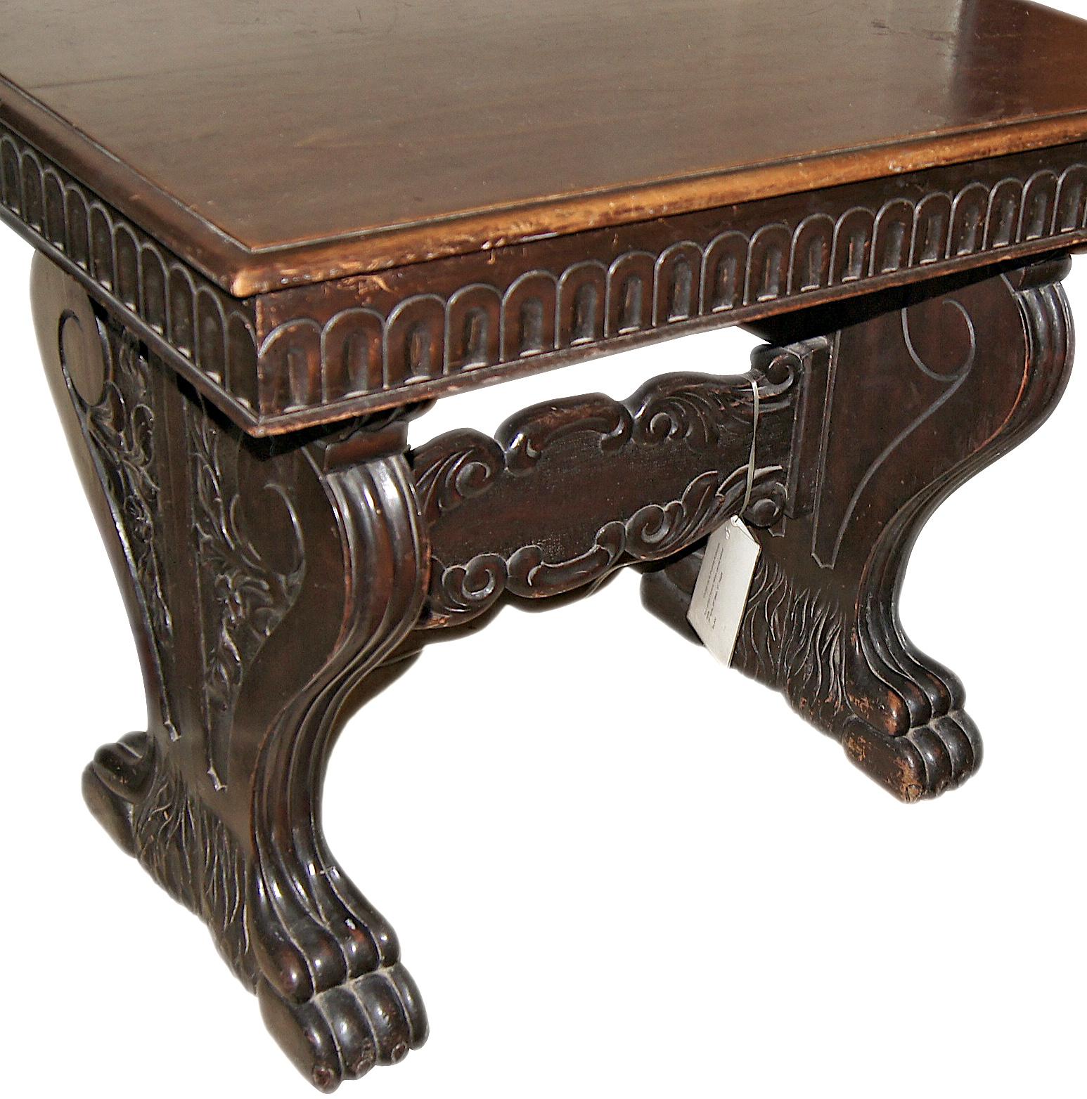 Circa 1900 Italian carved walnut table with lion's paw feet, scrolling motif on sides and drawers in apron.

Measurements:
Height 31.75