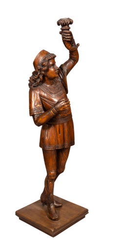 Torchere in legno di noce intagliato di un ragazzo in piedi che tiene una torcia