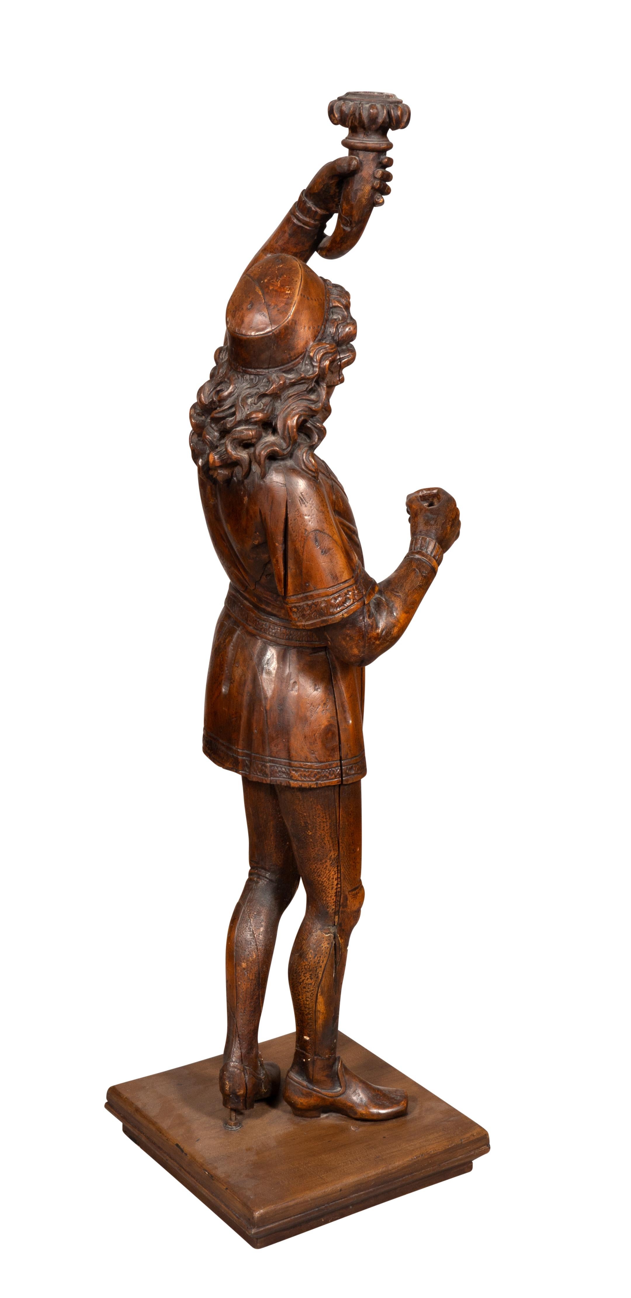 Italian Carved Walnut Torchere Of A Standing Boy Holding A Torch In Good Condition For Sale In Essex, MA