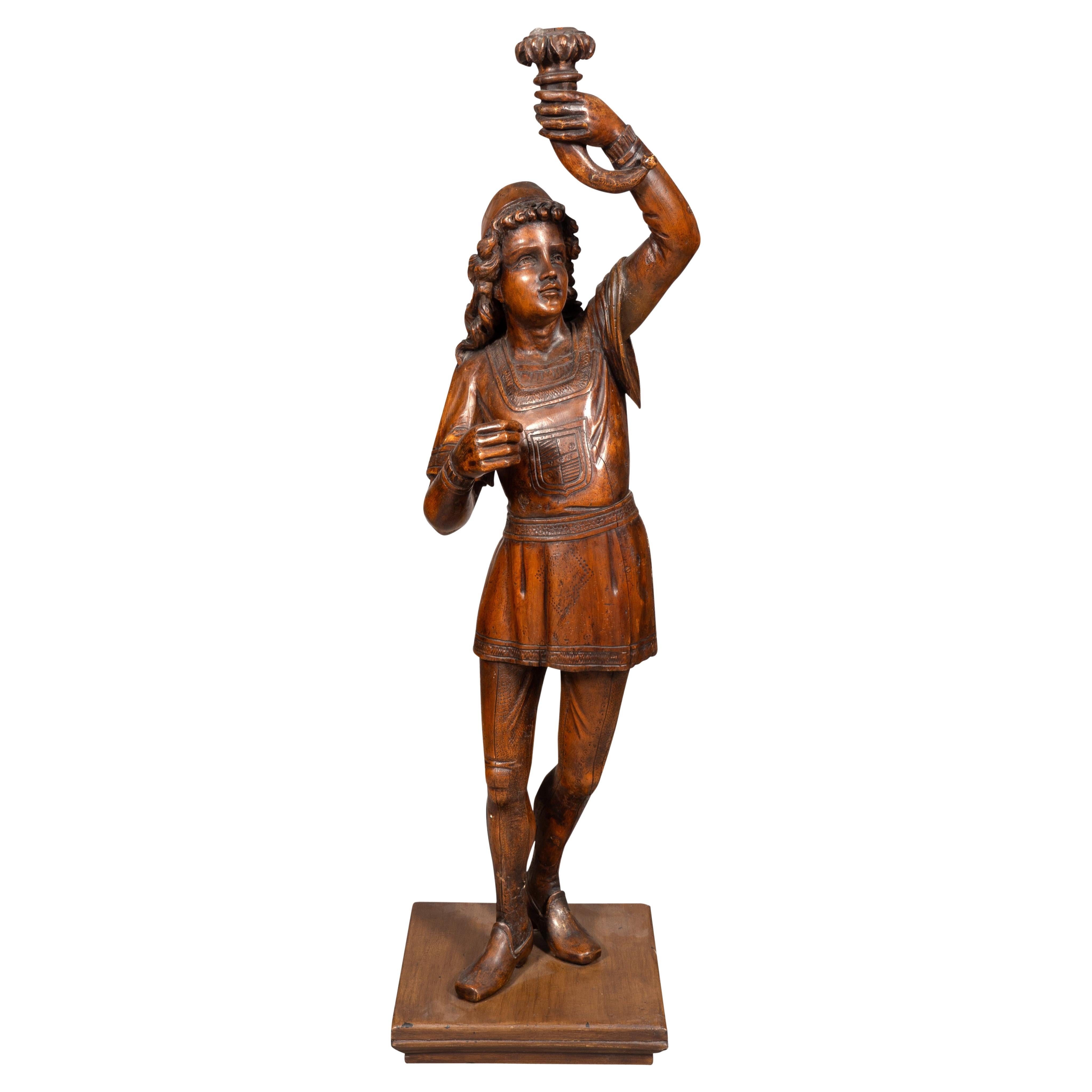 Italian Carved Walnut Torchere Of A Standing Boy Holding A Torch