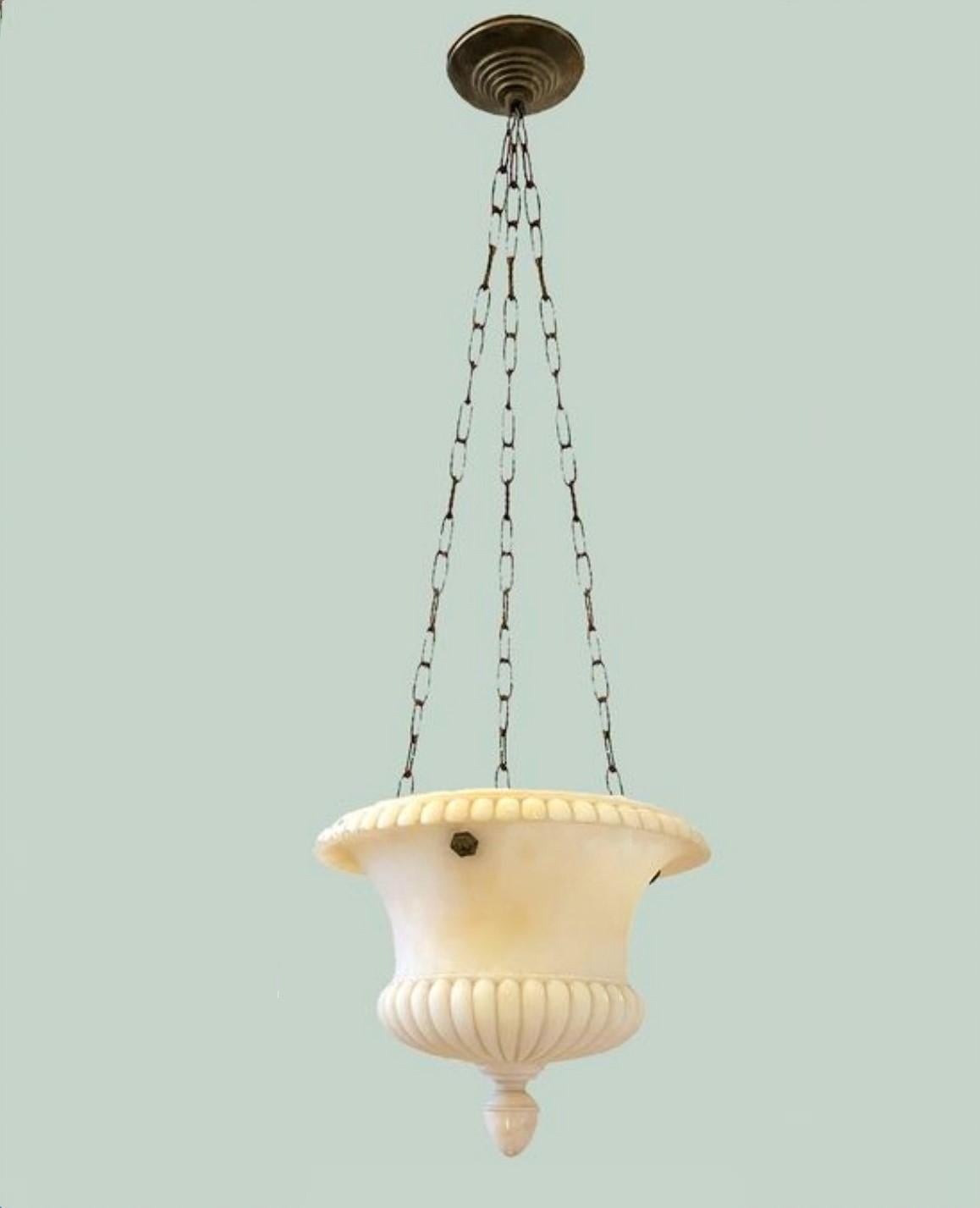 A very elegant hand-carved white alabaster neoclassical style pendant lantern manufactured in Italy in the late 19th century.
The dome is shaped like an antique Greek Crater perfectly balanced by the bronze patinated chains connecting to a canopy,