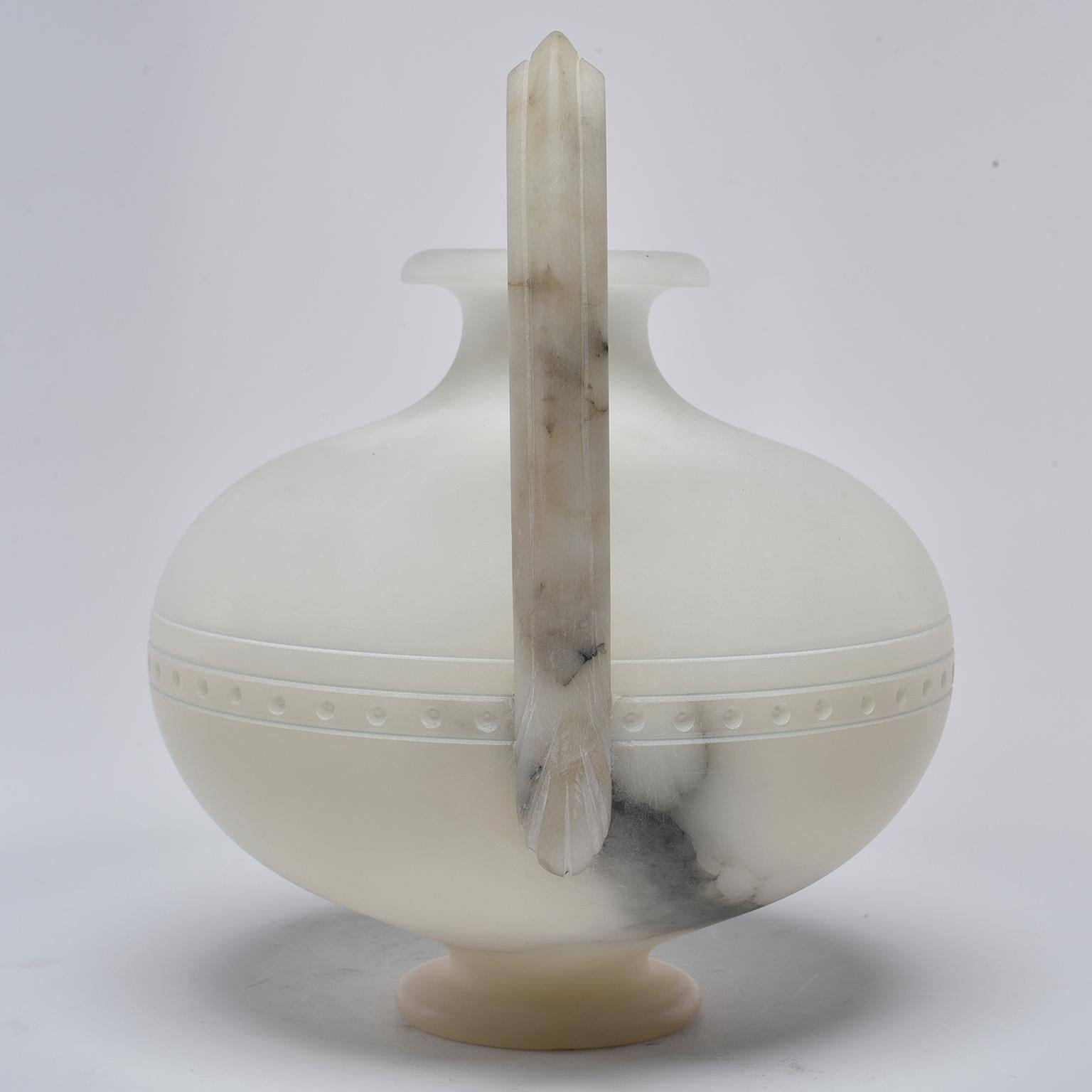 New, hand carved white alabaster vessel made for us by Italian craftsmen features globe shaped body with tall, dramatic handles.