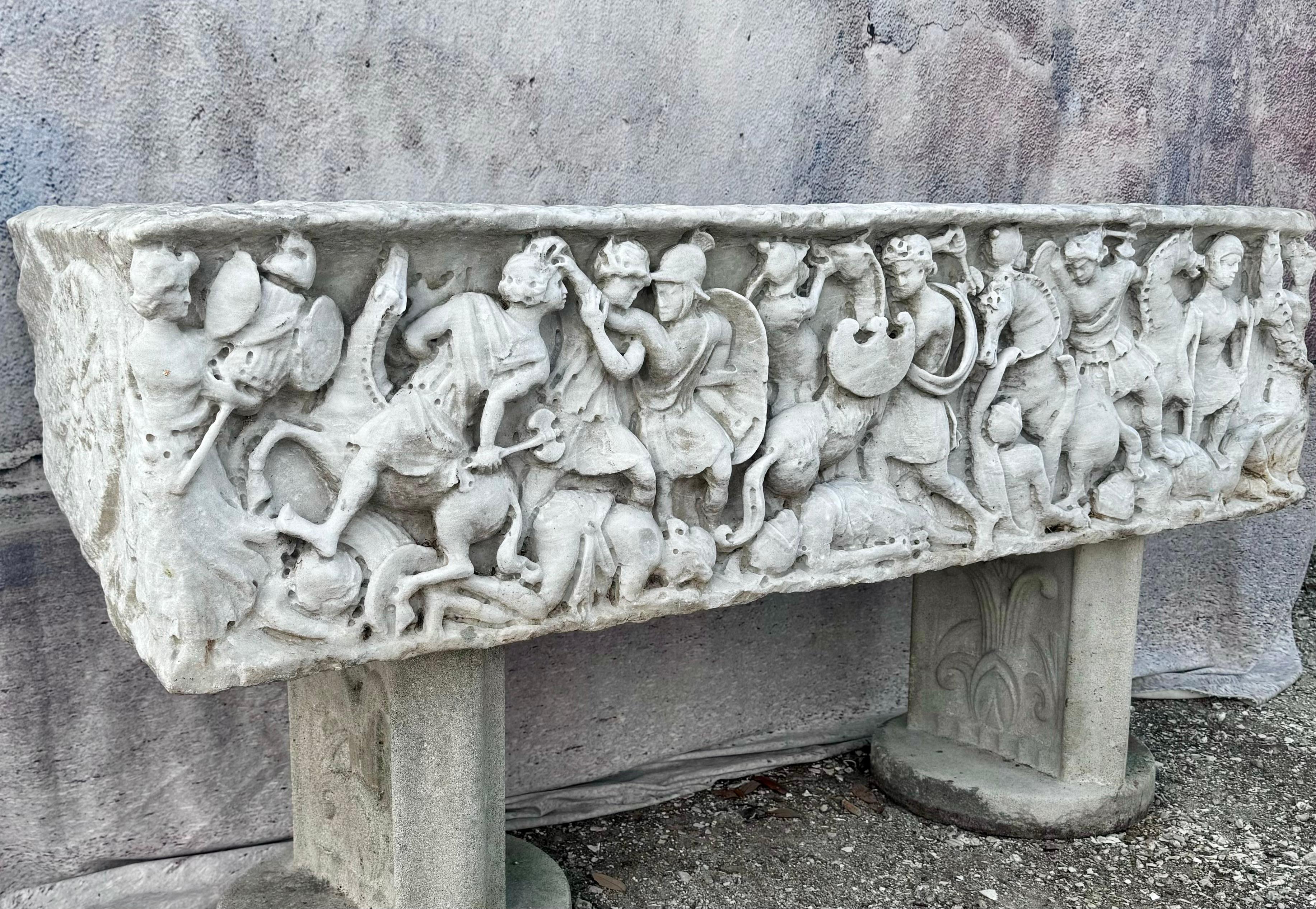 This magnificent Italian carved marble planter sarcophagus epitomizes the craftsmanship and artistic finesse of the Baroque period. Hewn from a single block of pristine Carrara marble, its surface bears the testament of masterful chiseling and
