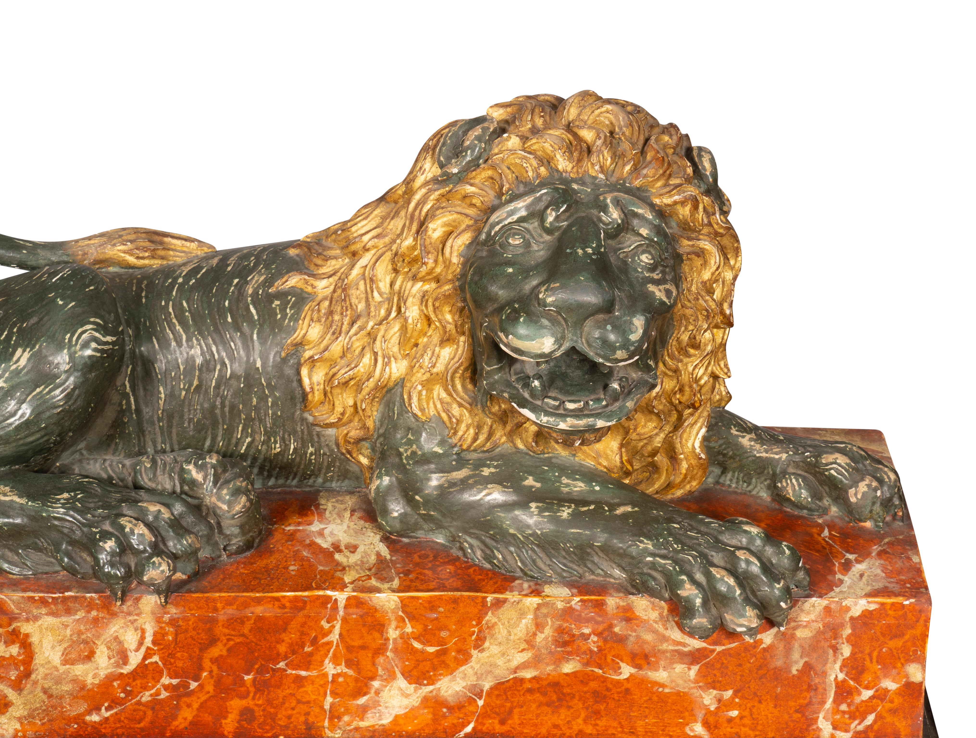 With a green bronzed reclining lion with gold leaf mane seated on a faux marble base. Estate of Los Angeles Dealer John Nelson.