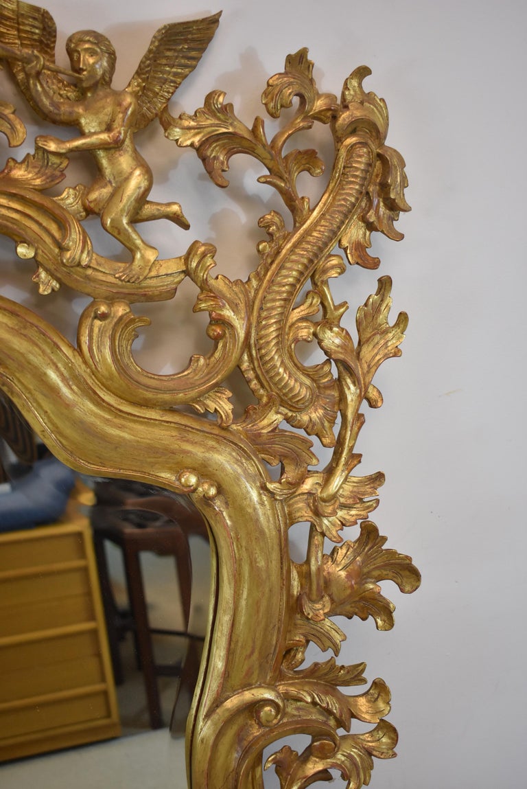 Italian Carved Wood Gold Gilt Trumpeting Angels Beveled Mirror For Sale