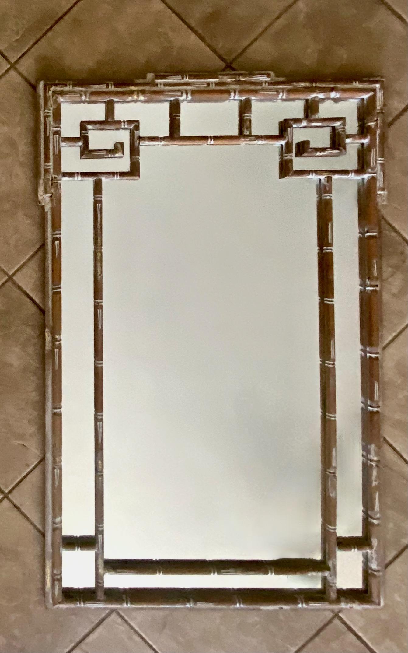 Italian carved wood faux bamboo and Greek key motif wall mirror. Frame is finished in an antiqued scraped white finish with small patches of gold leaf (see close ups for detailing).