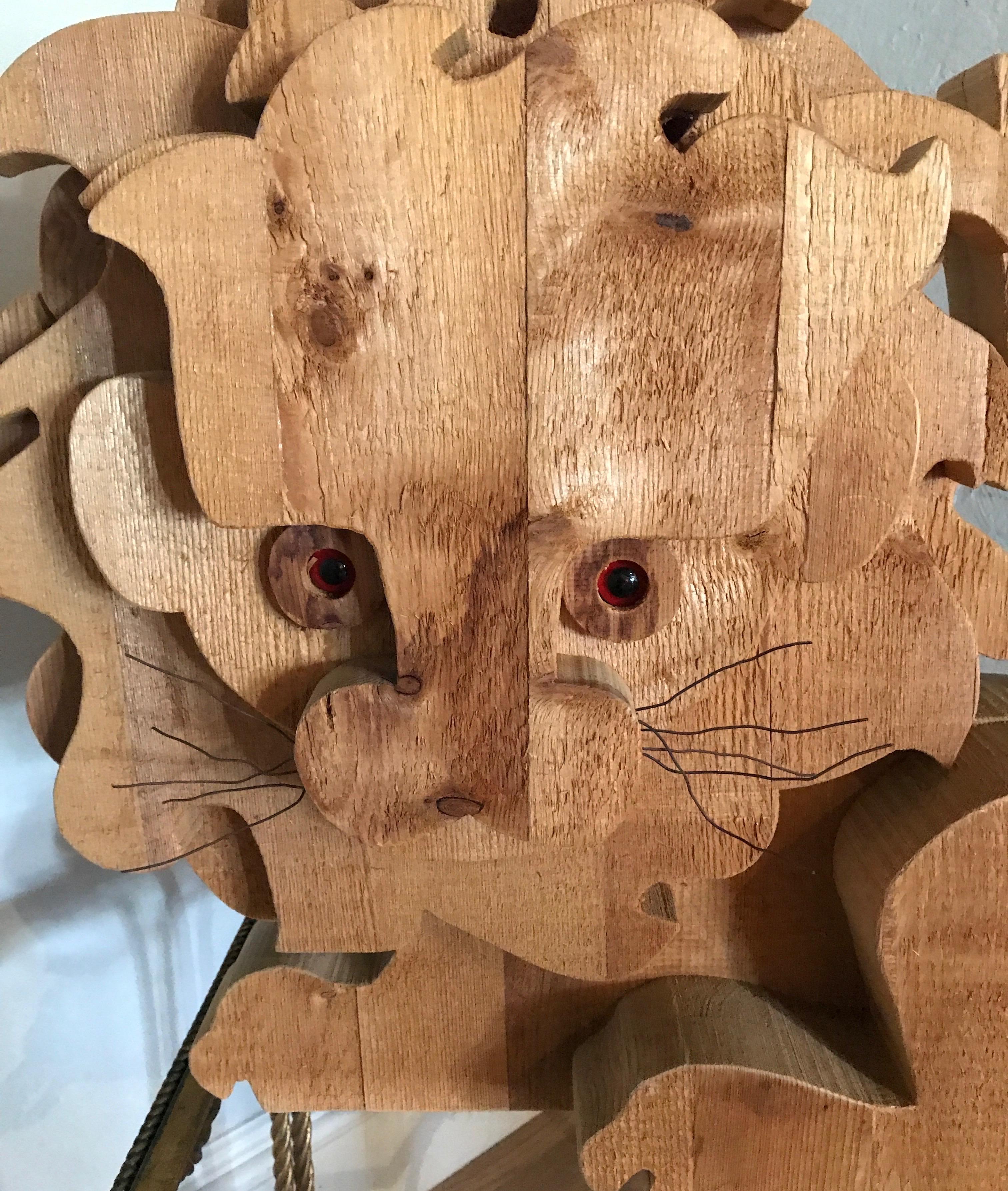 Whimsical modern wood sculpture of a lion. His eyes will capture you.