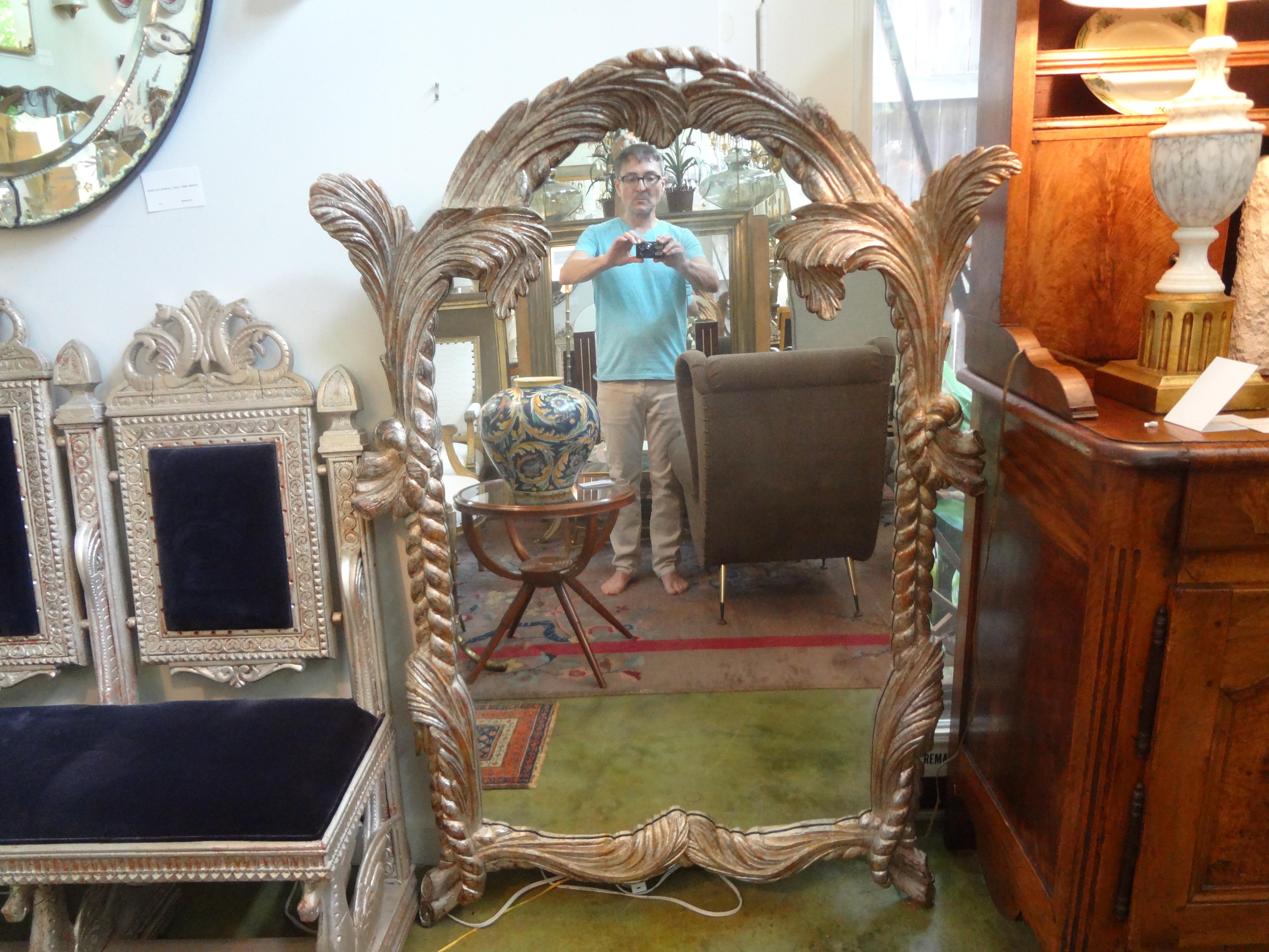 Stunning large Italian midcentury carved wood silver leaf mirror. This beautiful Italian Hollywood Regency silver gilt mirror has a palm frond motif. Featured Serge Roche, Dorothy Draper or John Dickinson inspired silver leaf floor mirror or