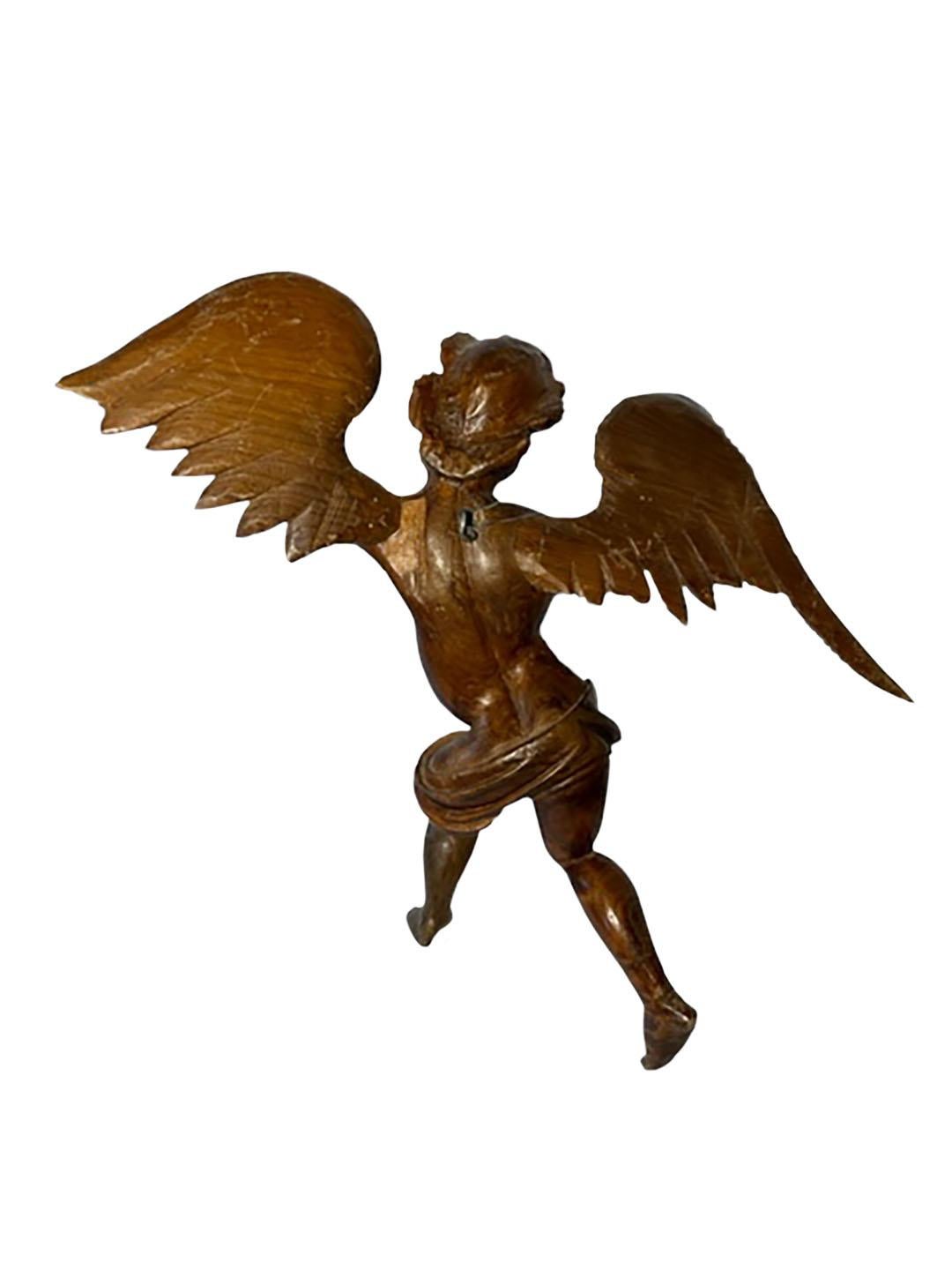 A pair of wonderful 20th century wood carved Italian angels spreading wings.