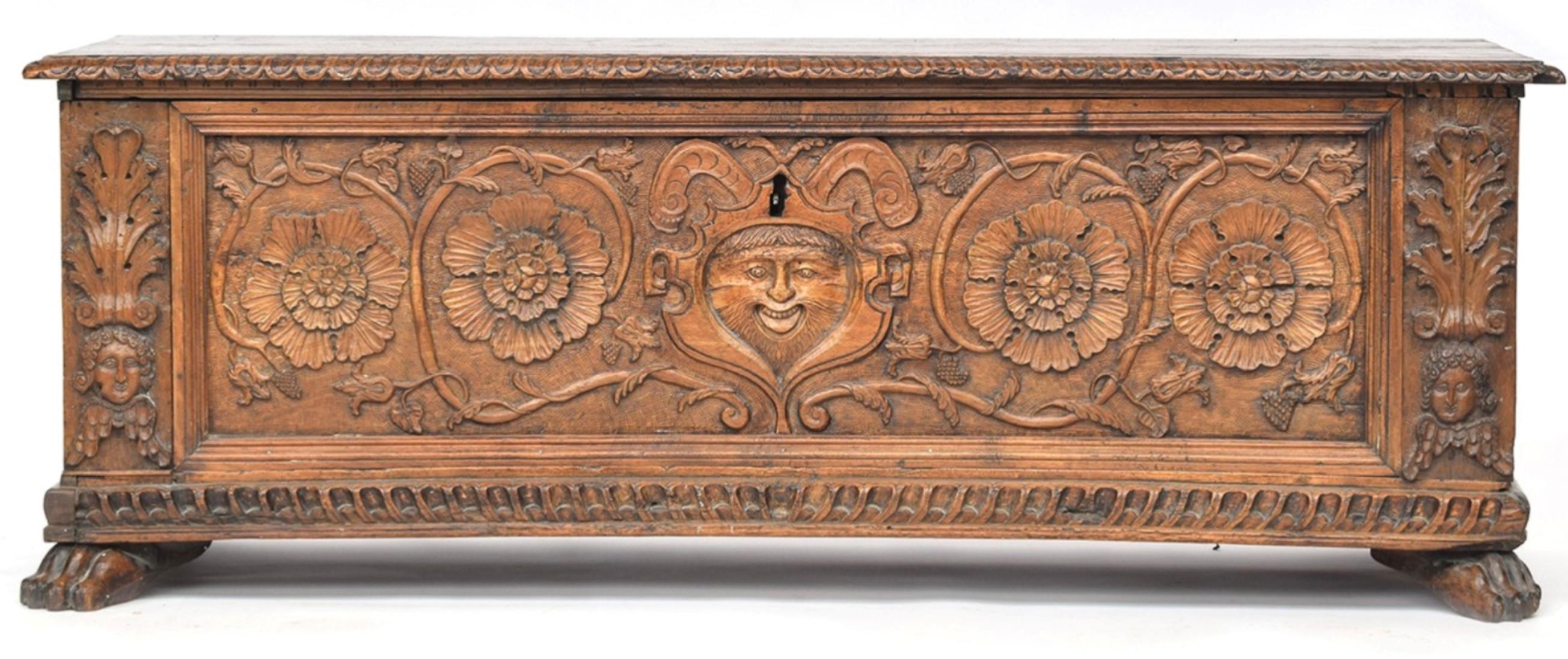 Absolutely stunning and elaborately carved 16th century and later Italian walnut cassone / wedding chest, with hinged lid with gadrooned edge. The front panel hand carved with central human mask, and floral motifs, outer acanthus detail is set above