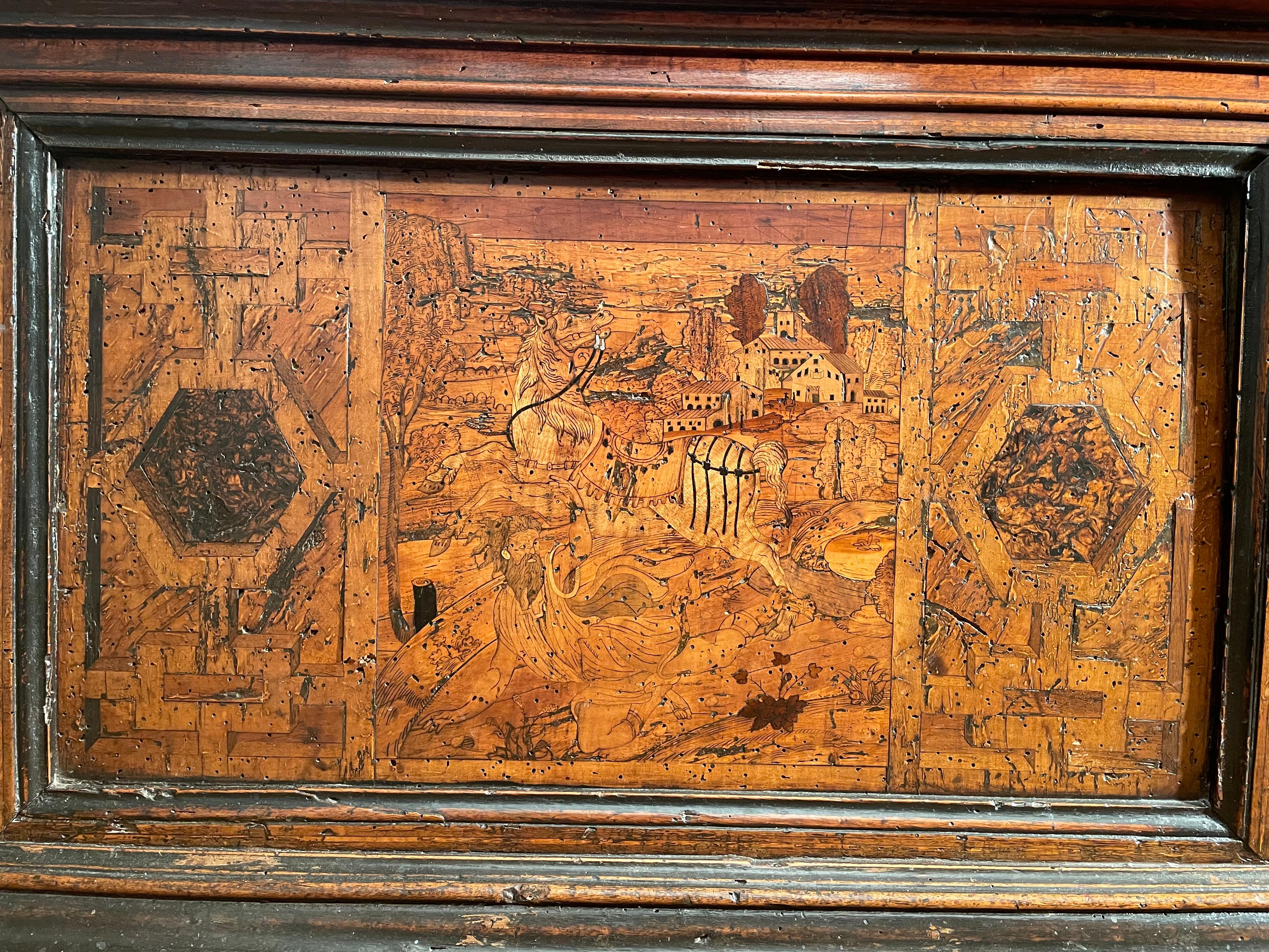 This cassone inlaid fruit wood on a walnut background, has a very beautiful decoration with geometric patterns and foliage scrolls. On the facade, two hagiographic scenes represent the conversions of Saint Paul on the left and Saint Hubert on the