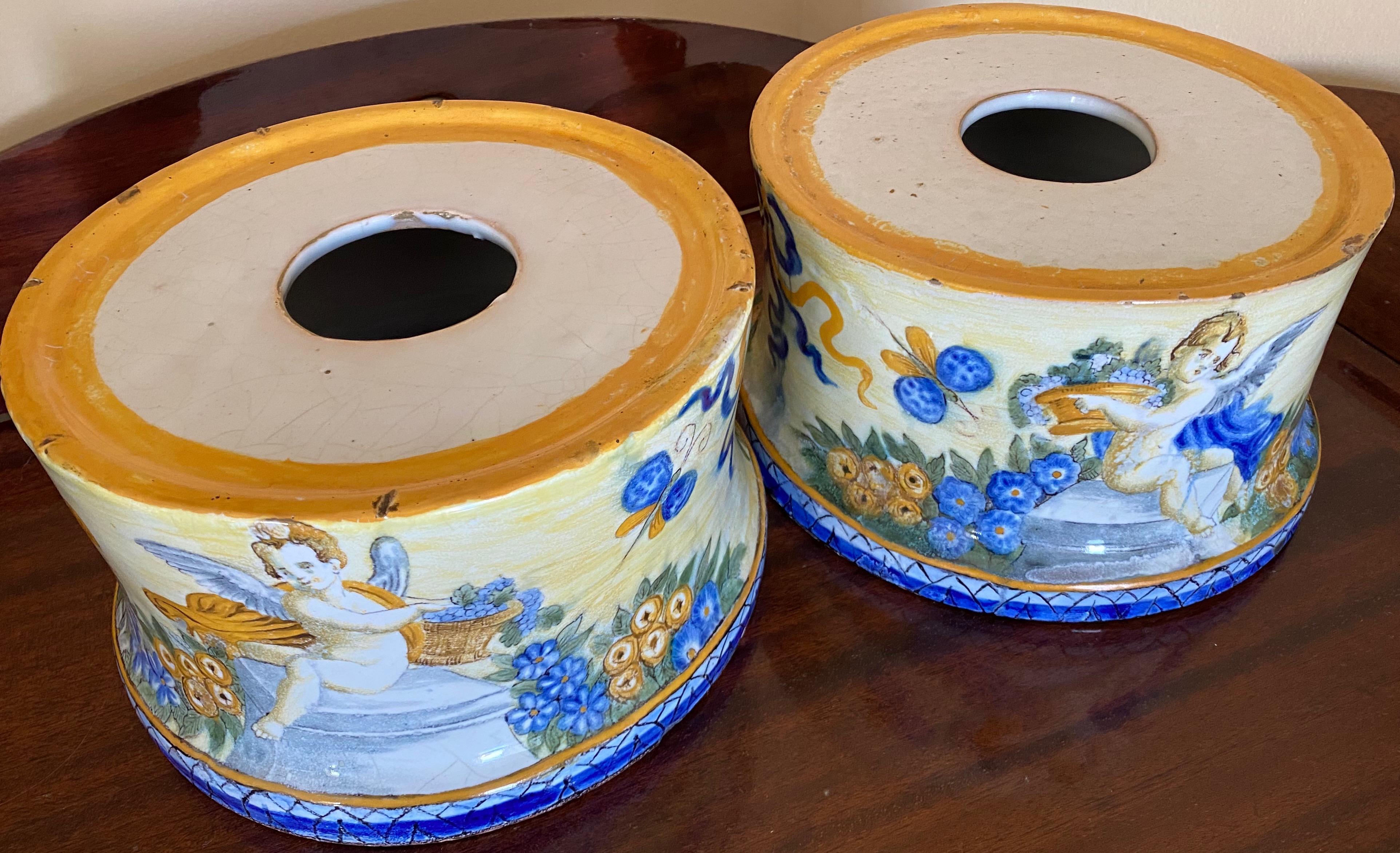 Italian Castelli majolica bases, Circa 1800.

This pair of bases for large vases are a typical example of the high quality manufacturing of the Castelli Majolica. Each of the 2 bases has painted on the surface pairs of winged cherubs seated on