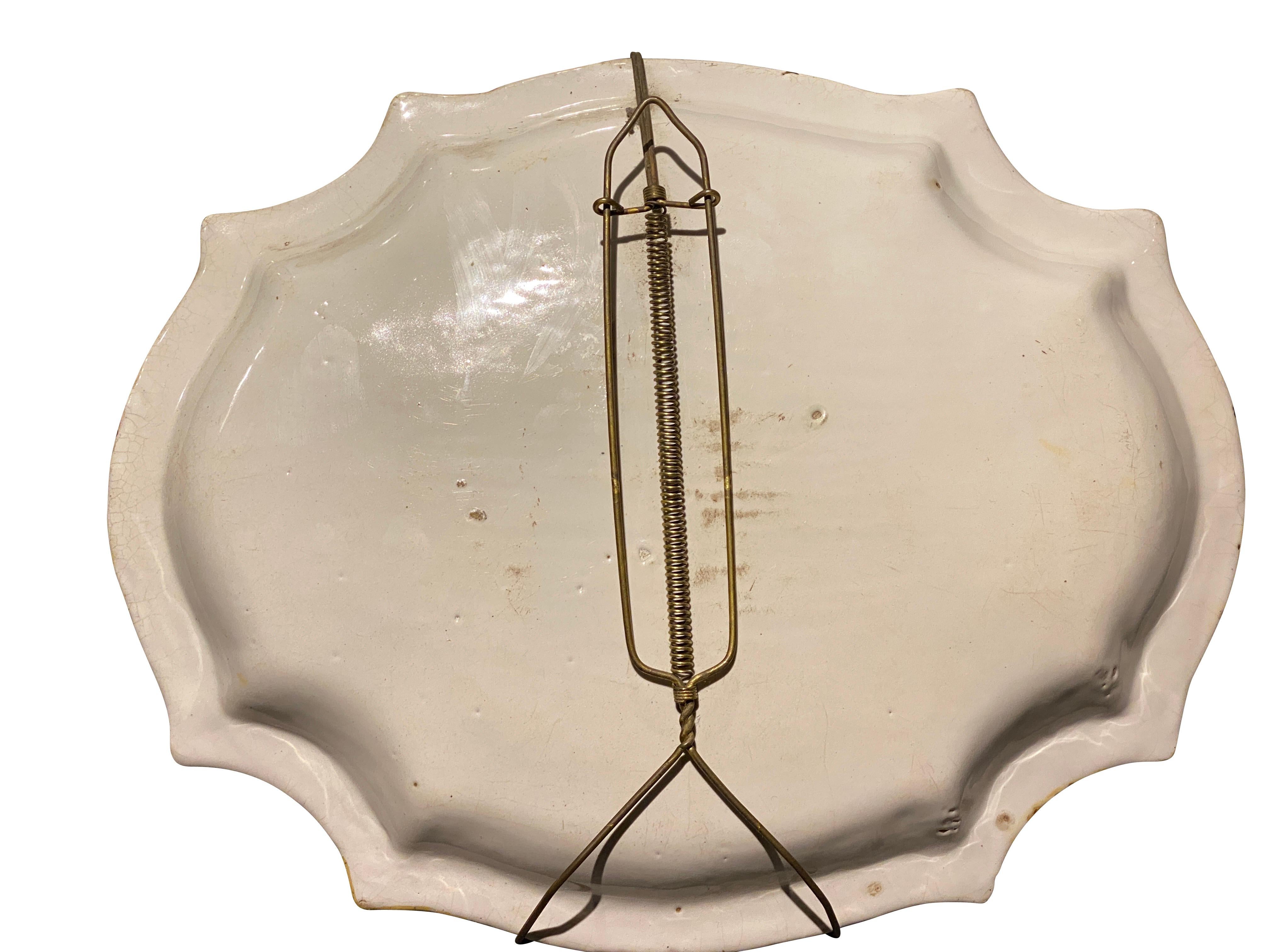 Shaped oval beautifully painted with figures in a landscape.