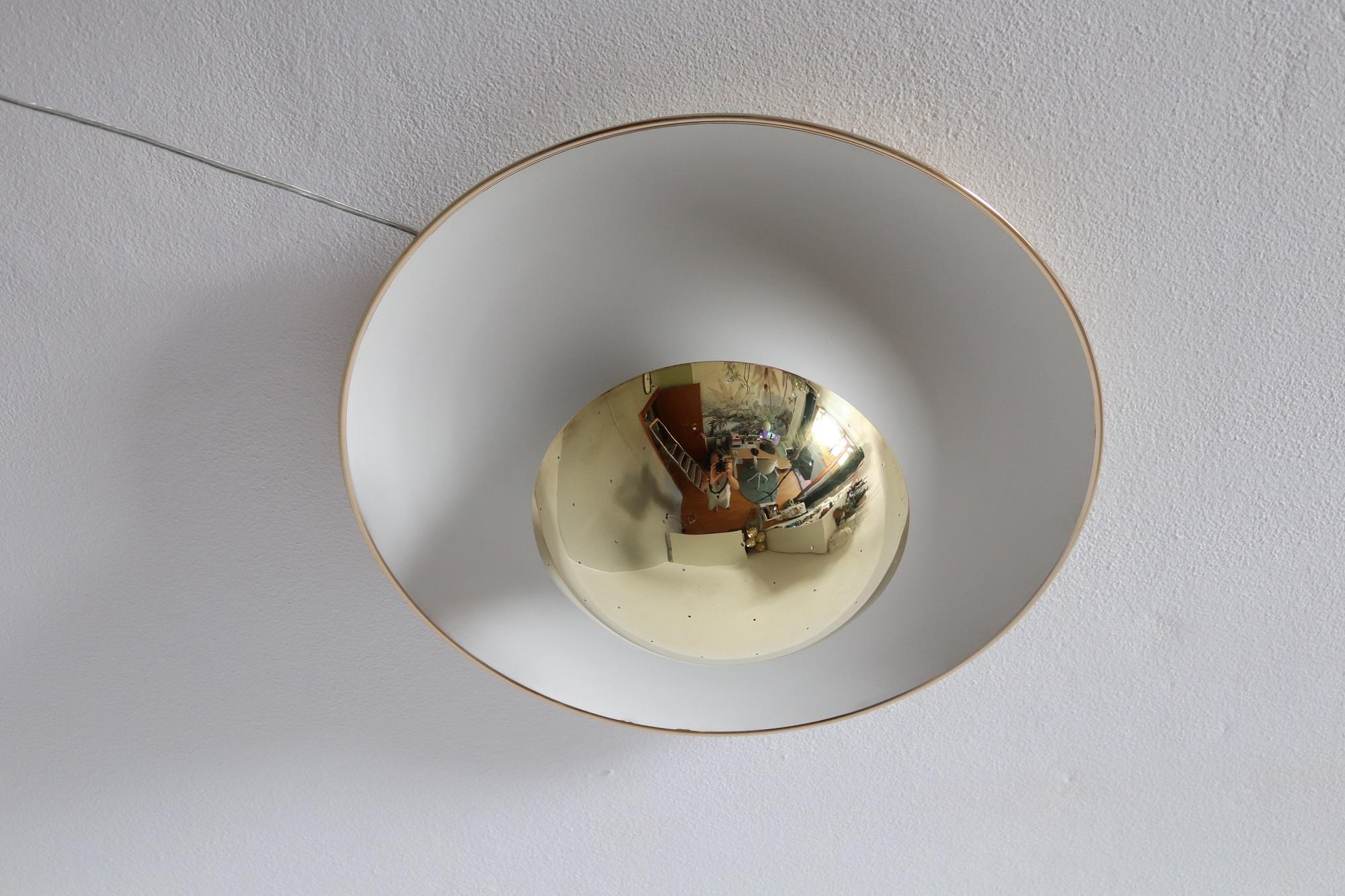 Beautiful elegant ceiling lamp or flush mount lighting, Italy, produced in the 1950s.
The big ceiling plate is made of varnished aluminium with brass edge.
Downgoing in a tulip shape, on the opposite side is fixed a round dome of full brass, which