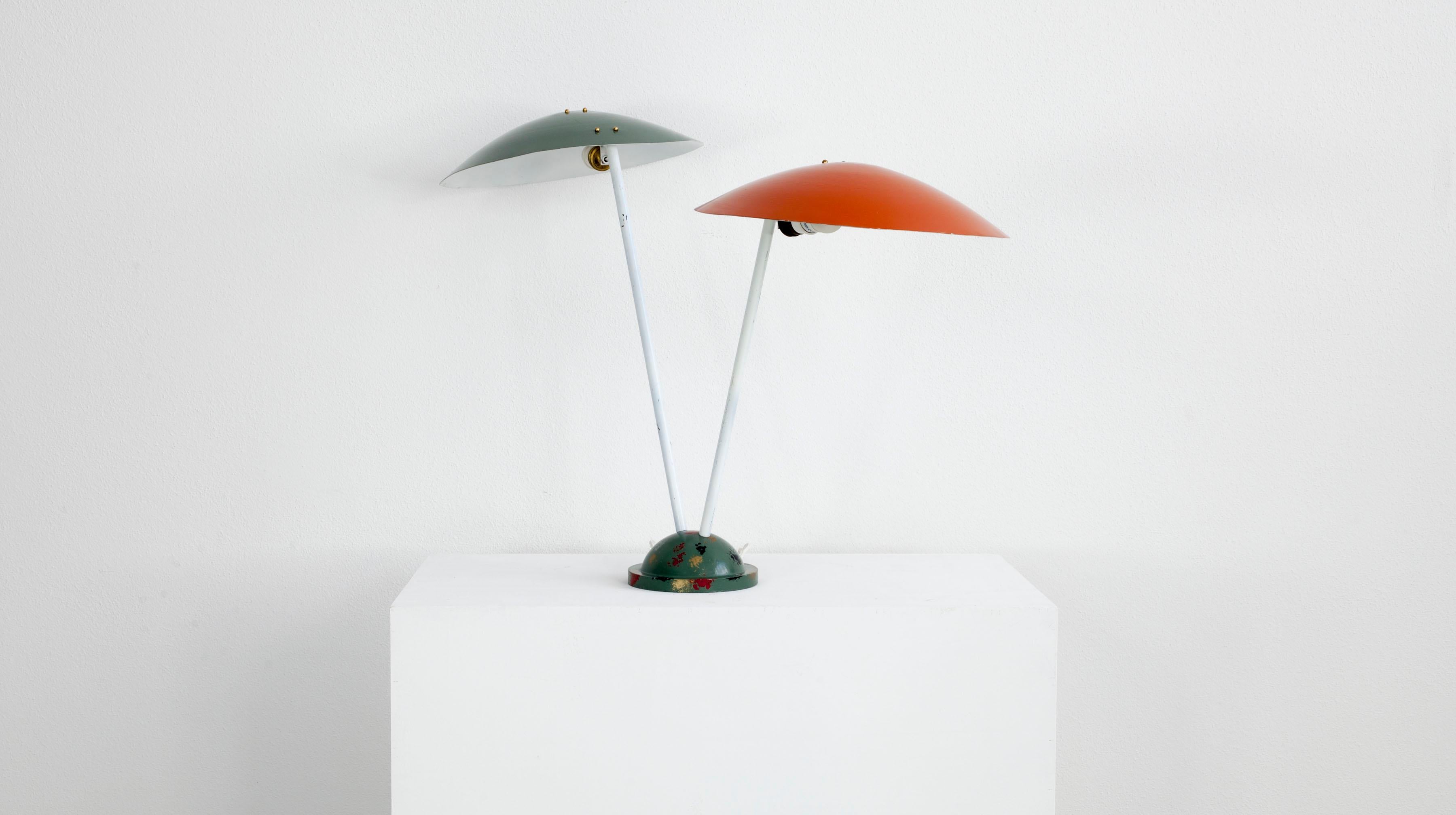 Italian lamp from the 1950s. The lamp has a metal frame painted white and aluminum shade painted orange and green. It is suitable for ceiling, table or wall mounting. It has two E 27 sockets and is in good condition except for patina due to