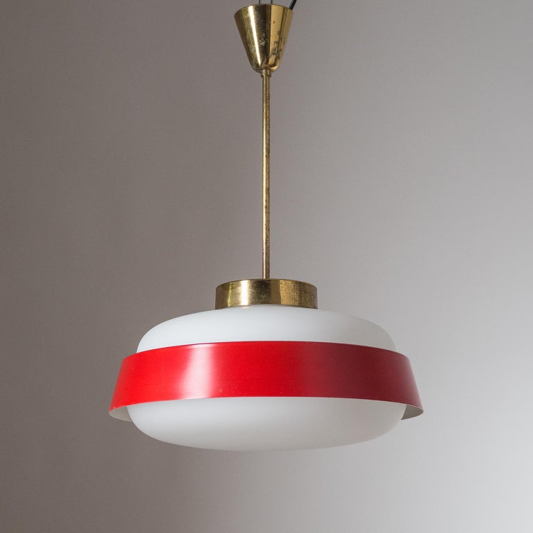 Fine Italian ceiling light from the 1950-1960s. A large satin glass diffuser with a red lacquered 'Saturn' shade suspended by brass hardware. Good original condition with partially heavy patina on the brass. One E27 socket with new wiring.