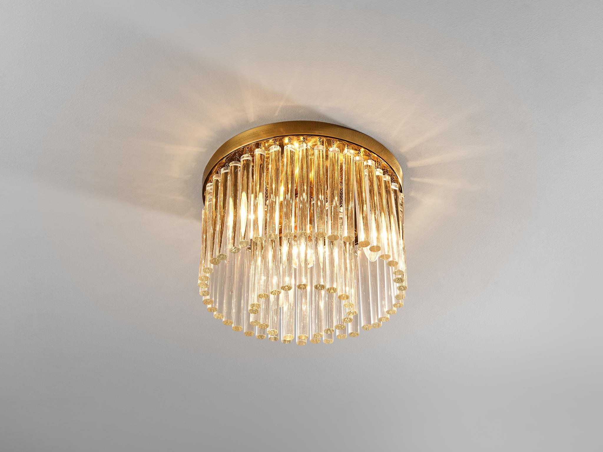 Ceiling light, glass, brass, Italy, 1950s.

An exceptional crafted chandelier of Italian origin. The design features a round canopy executed in brass and adorned with glass prisms arranged in two rows. All together creating a spectacular sight by