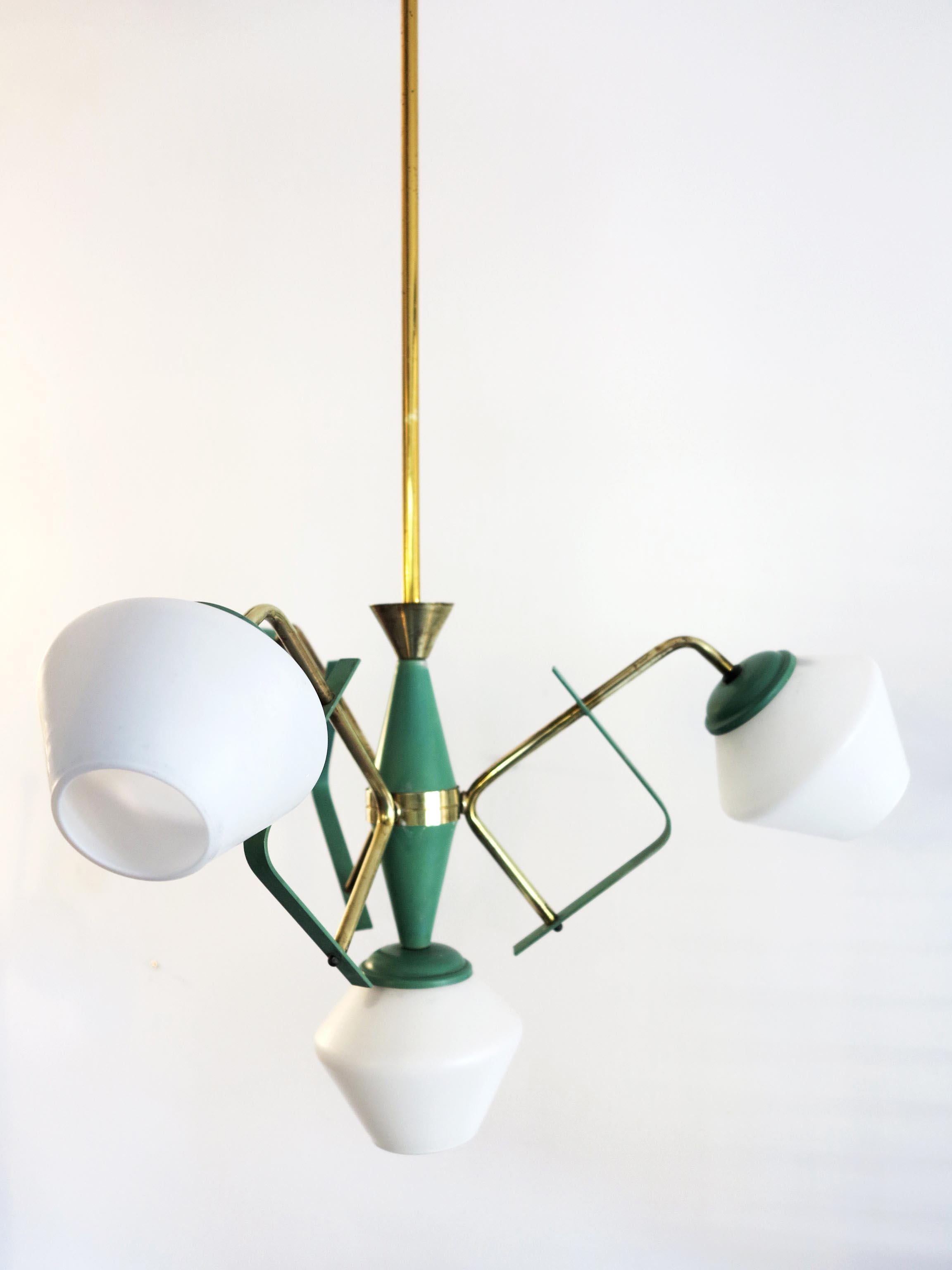 Italian ceiling lamp by Stilnovo in opaline glass with green and brass details.
The lamp presents four opaline glass, three lateral and one in the centre.
There are beautiful element in metal green painted with polished brass details.