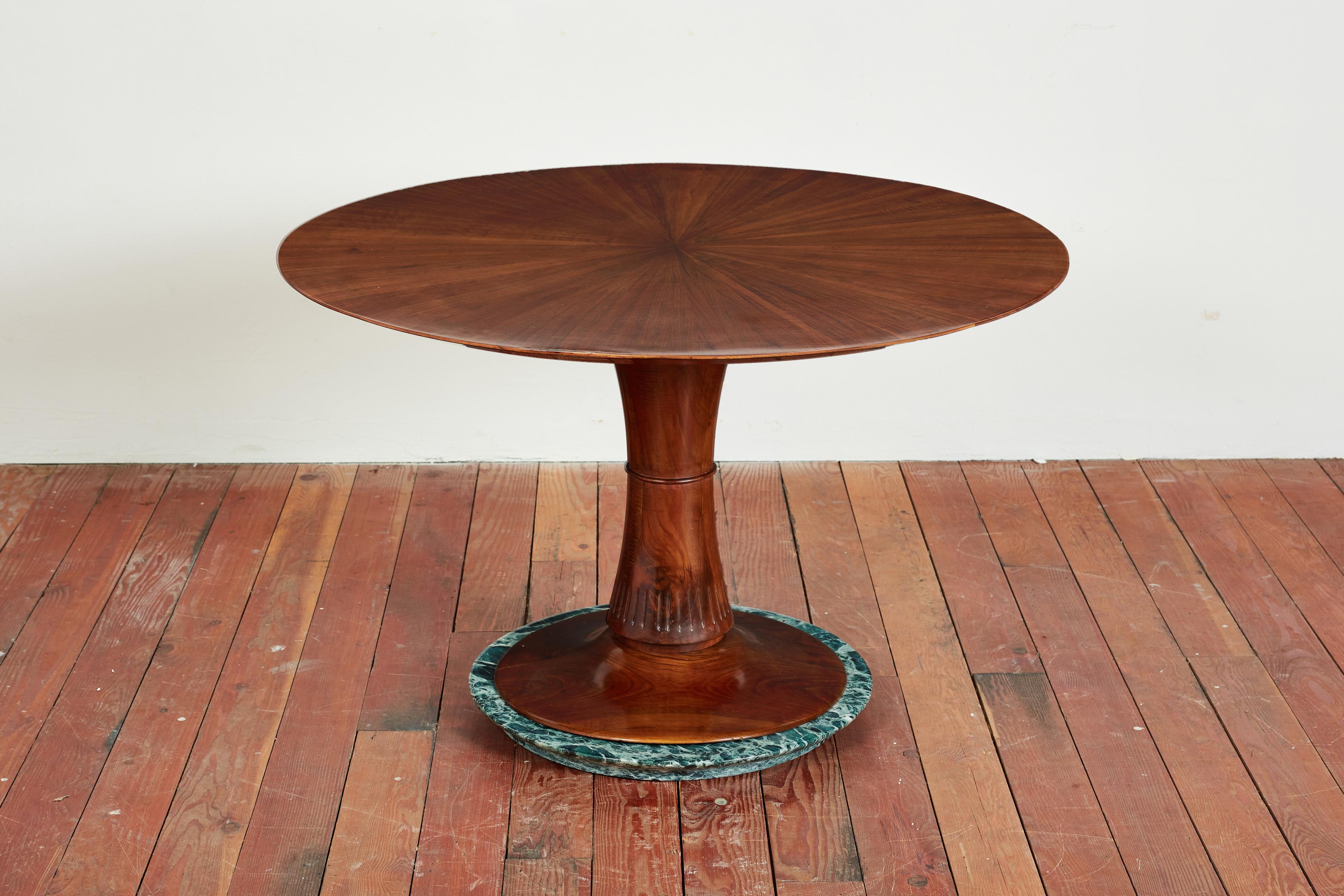 Exquisite circular wooden center table - 1950's, Italy 
Patterned wood top in the style of Carlo de Carli 
Carved wood pedestal base with intricate detailing
Green marble base.