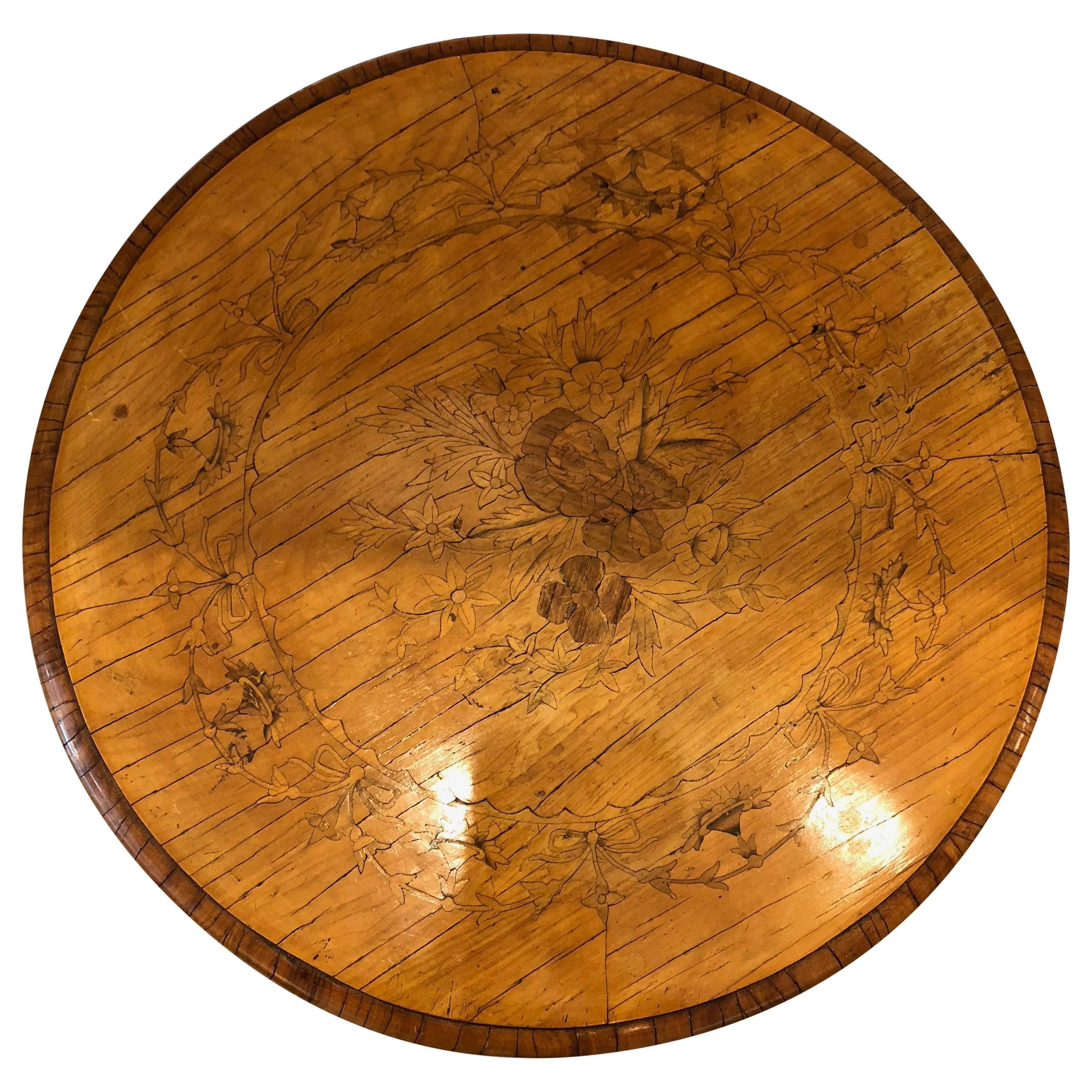 Antique Italian centre table with detailed marquetry. The top part of the table has floral and ribbon notes throughout.