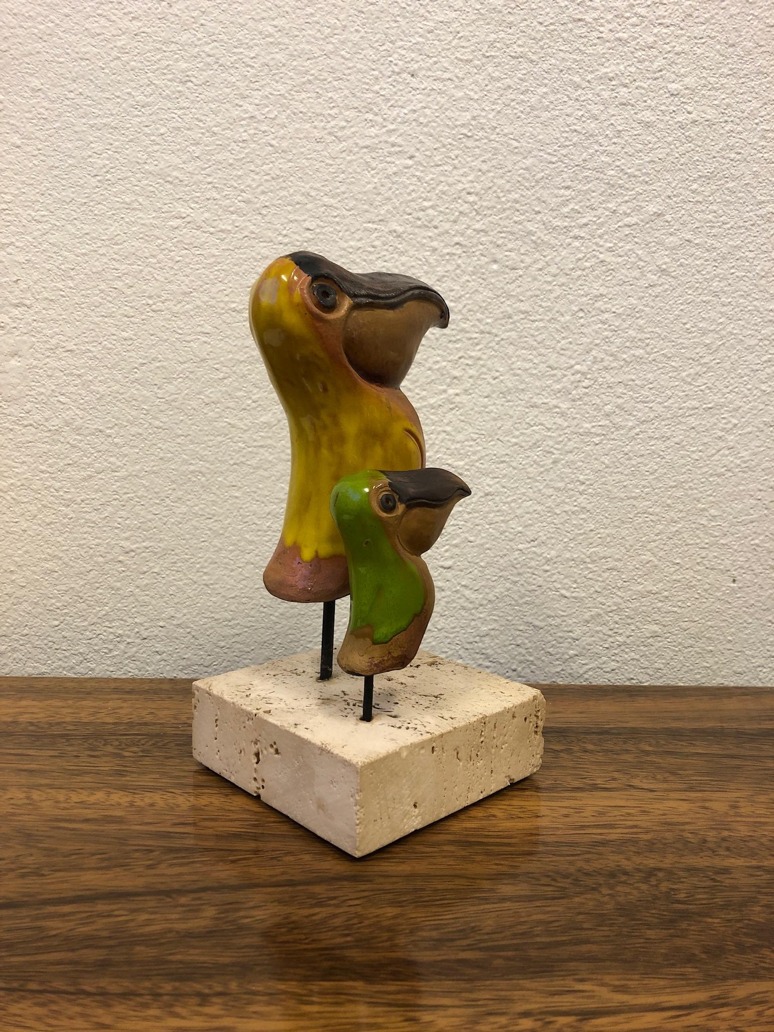 A beautiful Italian ceramic pelican mom and baby sculpture on a travertine base by Gli Etruschi for Raymor. 
Overall dimensions: 9.75” high, 4.75 wide, 4.75” deep.