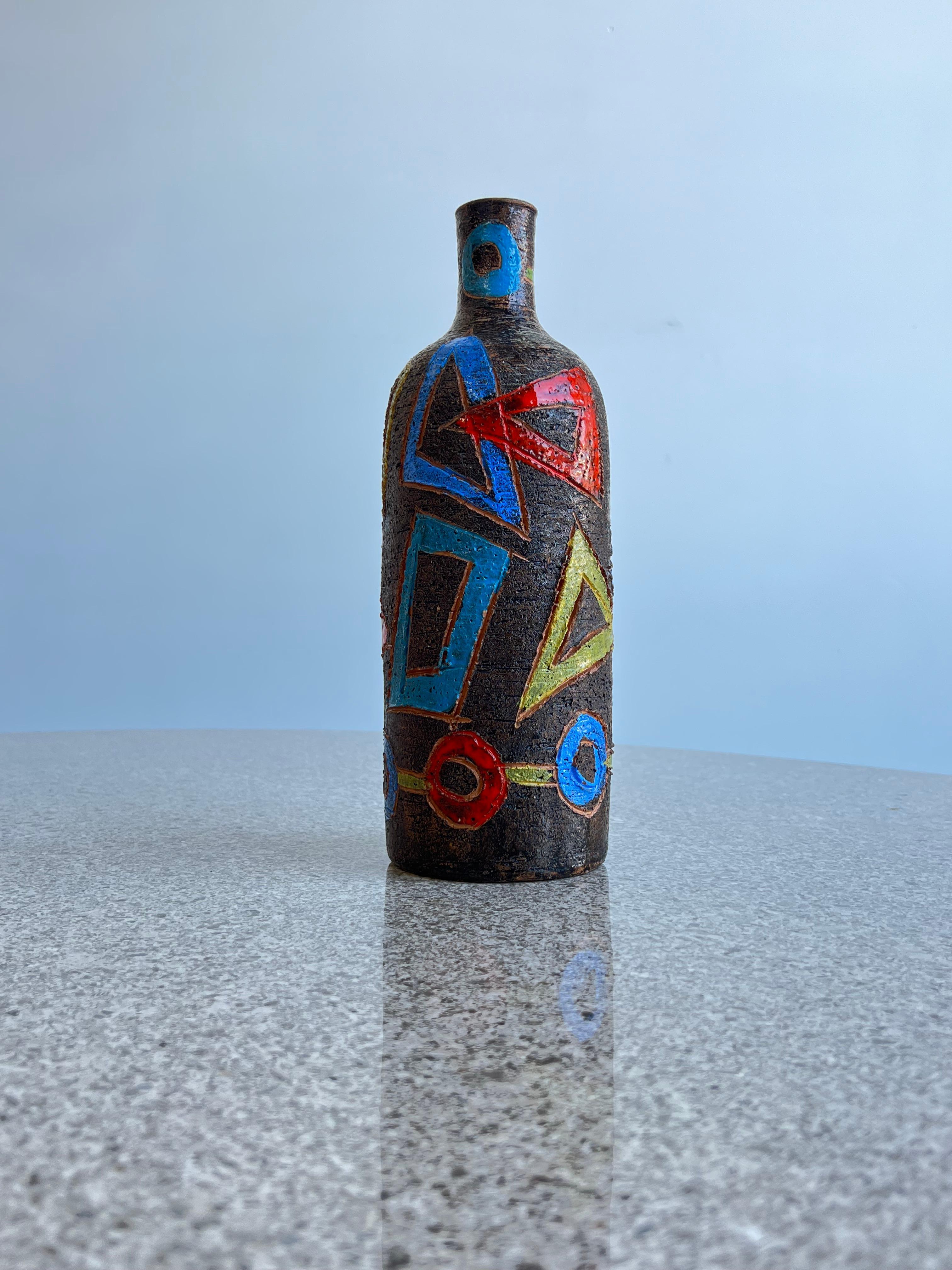 1960 Bitossi hand painted ceramic decorative bottle.
Stunning coulful ceramic by Bitossi, yellow, blue, green and red withy dark brown background with wrath texture ceramic surface.
Signed Italy on the bottom of the bottle. 
