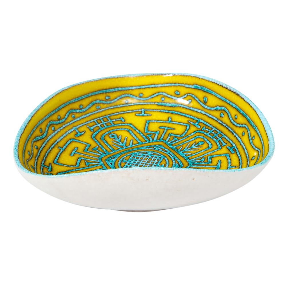 Italian ceramic bowl, abstract, yellow, blue, and white, tribal signed. Small to medium scale bowl with an interior decorated with an intricate tribal motif and glazed in a sky blue over yellow. The exterior of the bowl is white. Signed 