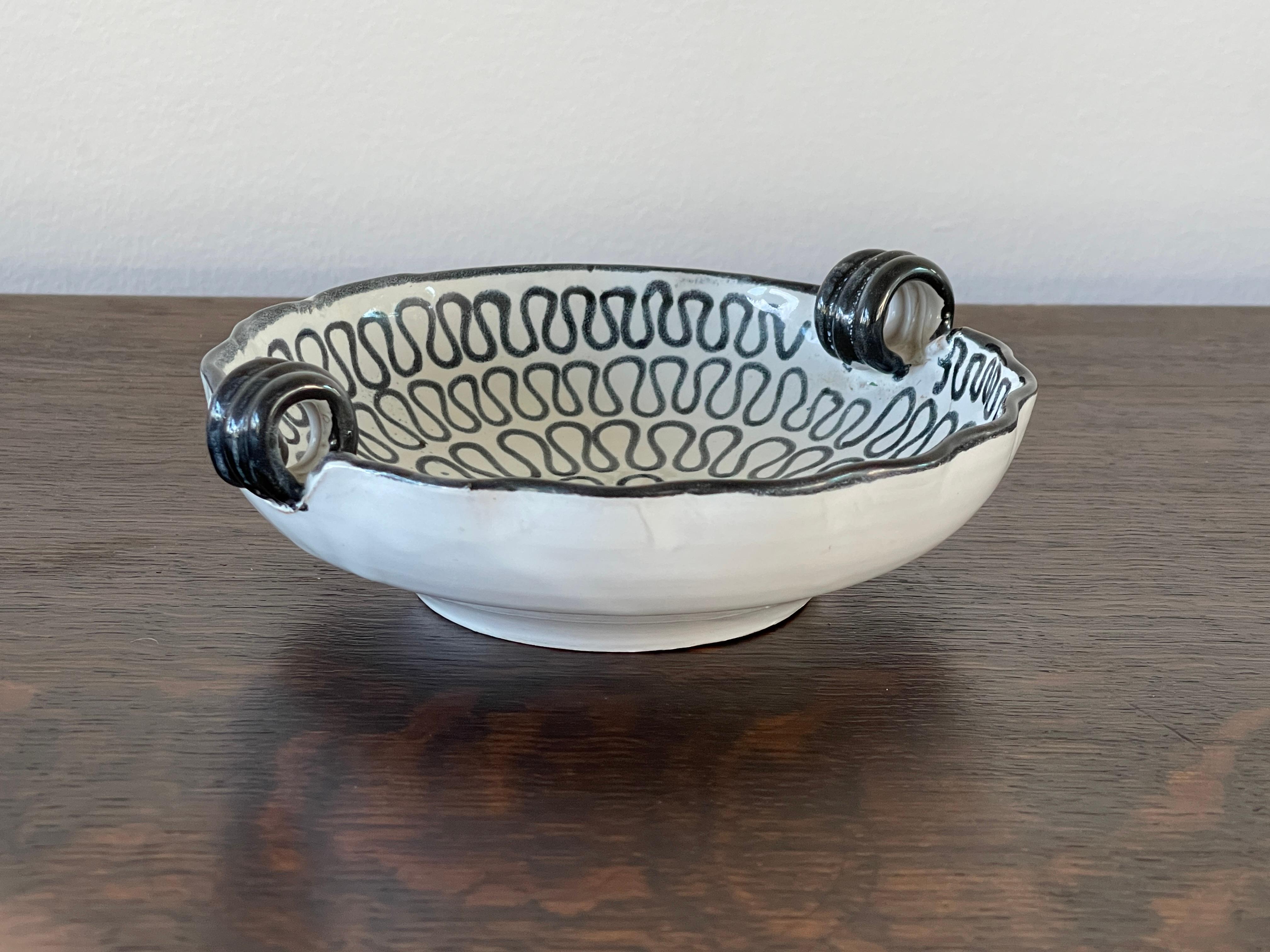 Petite sculptural Italian ceramic bowl with scalloped edges and black and white graphics.