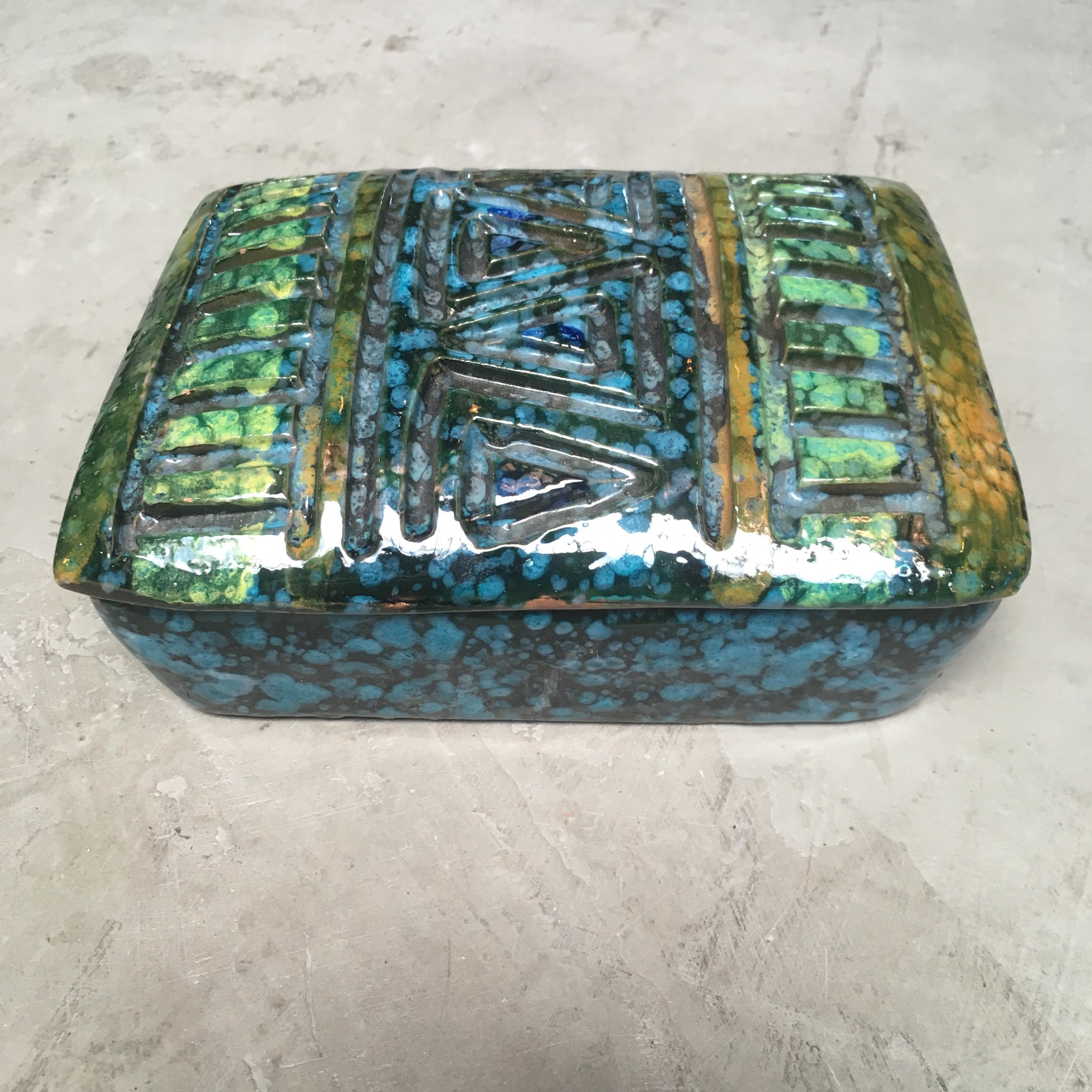 Beautiful Italian ceramic box with blue and green coloring. Marked Italy on underside. Great stash box and tabletop object.

 