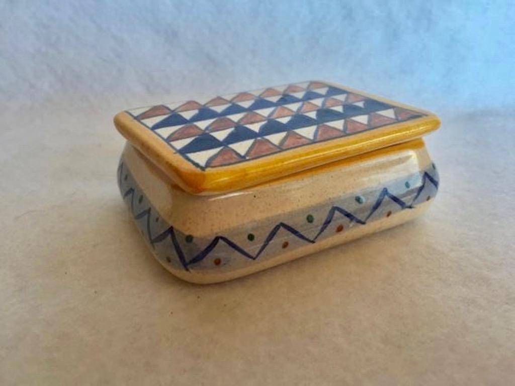 Pretty ceramic box made in Italy. Triangle motif with orange, blue and yellow coloring. Marked 