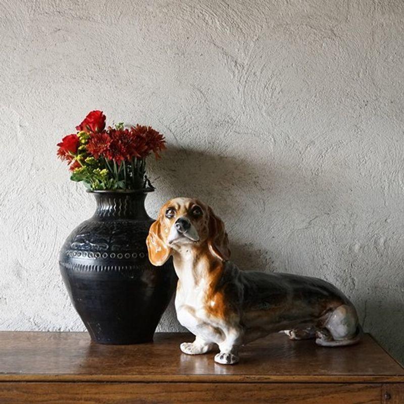 Mid-century sausage dog statue. Black, tan and white piebald coat glazed pottery doggy. Modelled with a lovely cheeky little face! Excellent quality unsigned but stamped ‘Made in Italy’ on his paws. Overall he is in good vintage condition, there is