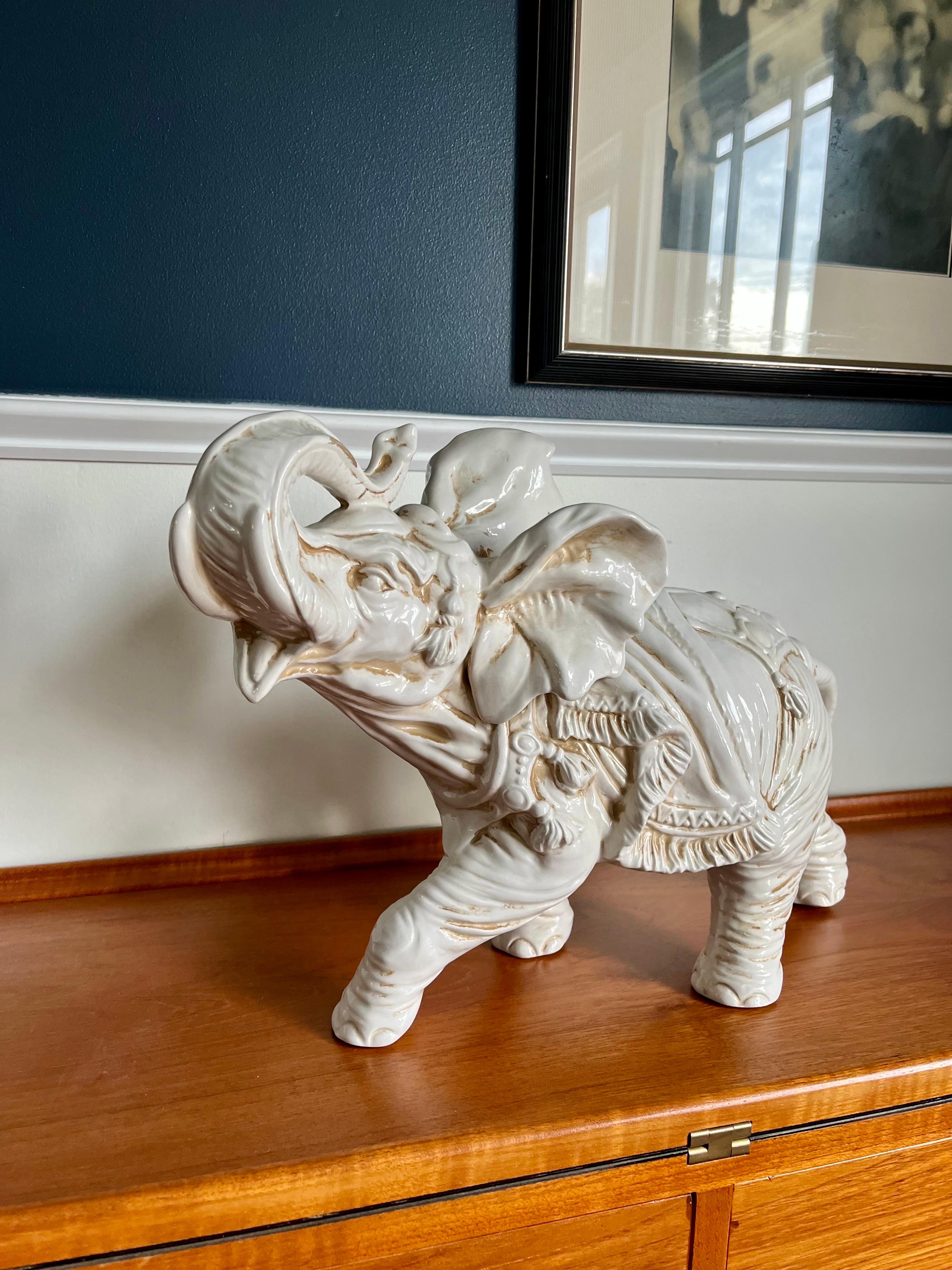 Beautiful white ceramic Elephant made in Italy. Lucky with trunk in an upward position. Great expression and detail. Original owner piece. Darker markings are from decades of wiping down, so I decided to leave the piece in its original condition. 